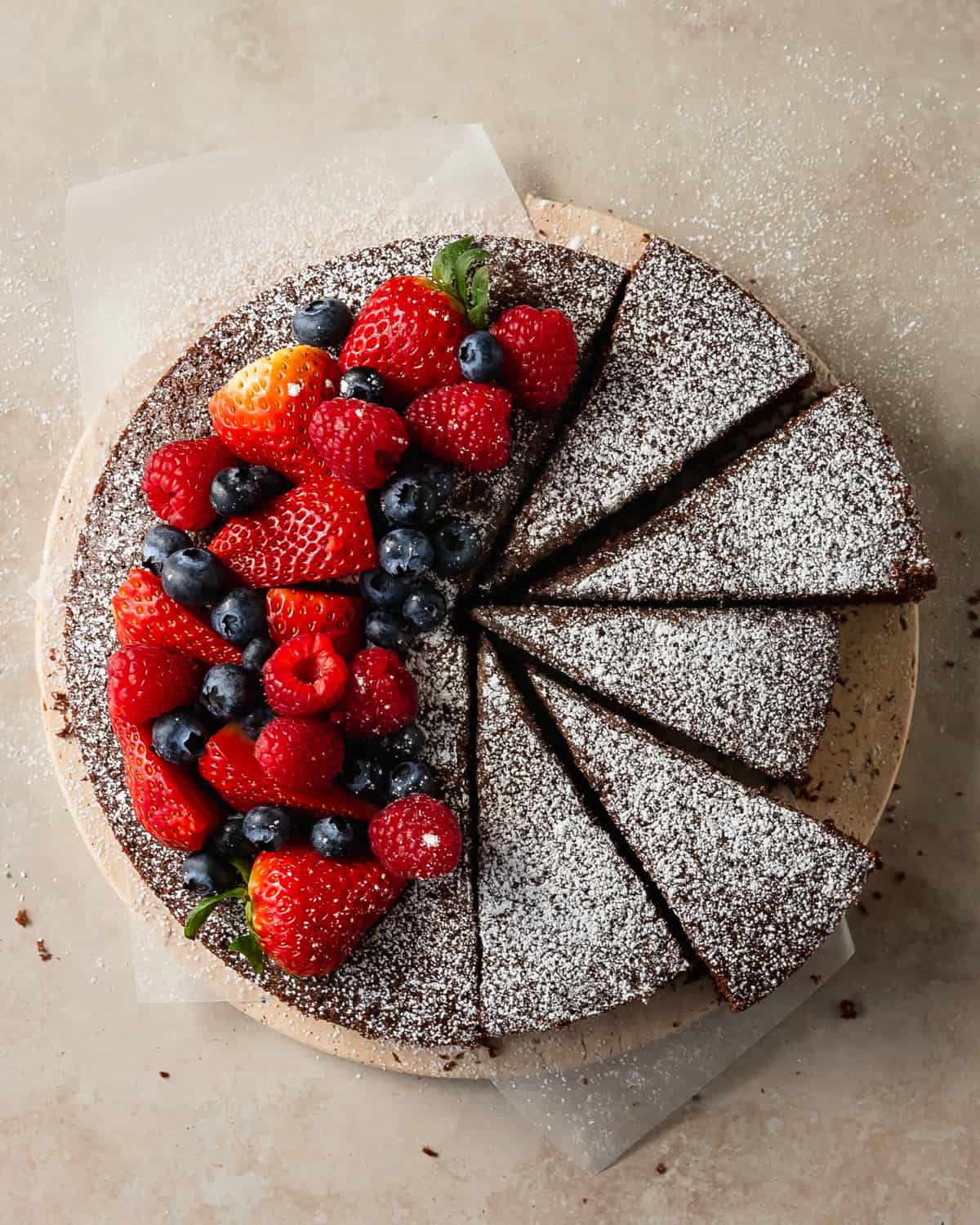 Chocolate olive oil cake is a deeply moist and tender chocolate cake made with rich and earthy olive oil. Top this simple olive oil chocolate cake with berries and fresh whipped cream for the perfect easy to make dessert. 