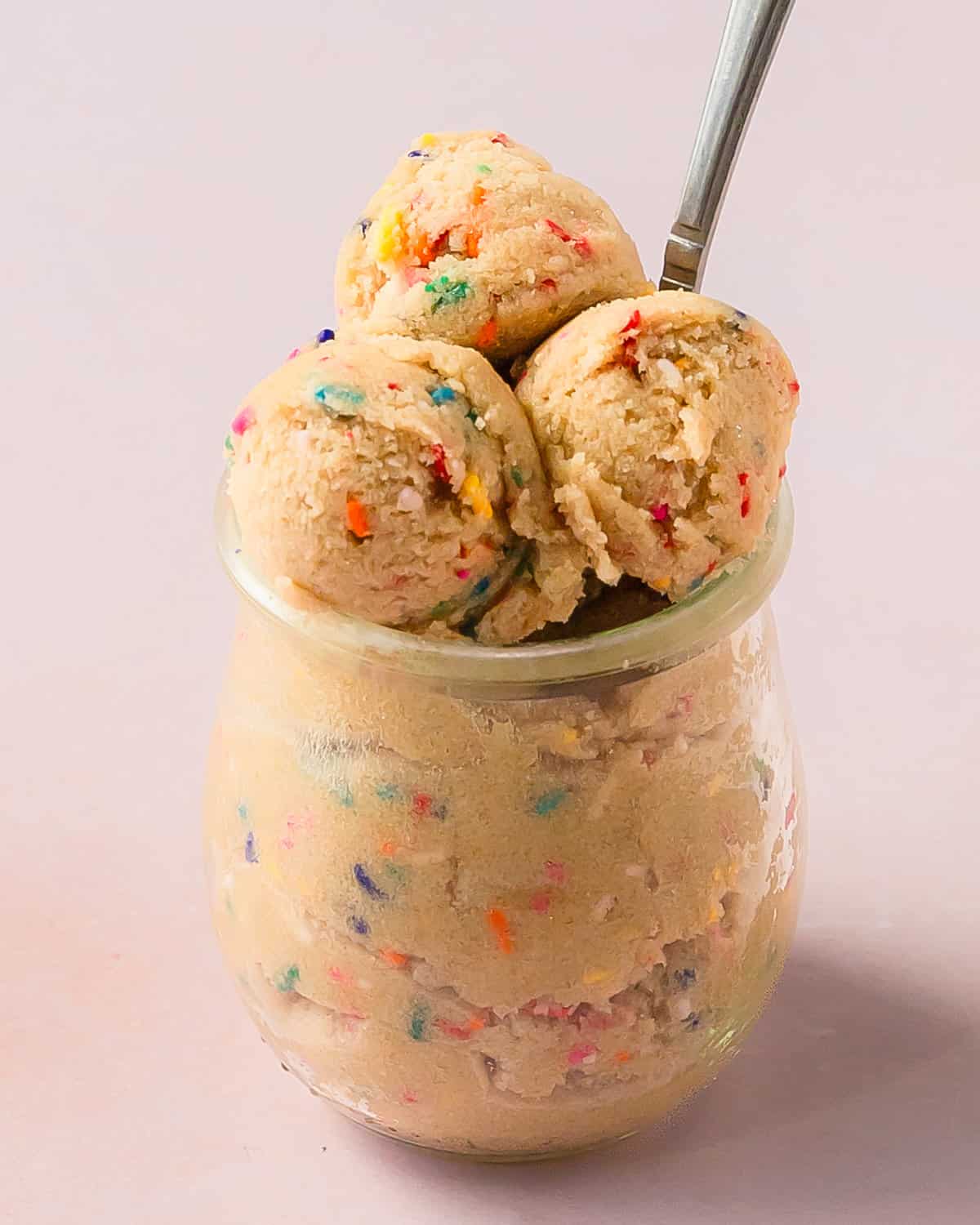 Edible sugar cookie cookie dough is a buttery, soft and sweet raw sugar cookie dough filled with sprinkles. This edible cookie dough is made with simple ingredients and takes less than 5 minutes to make. If you’re a fan of eating scoops of cookie dough by the spoonful, this easy edible sugar dough cookie recipe is for you!