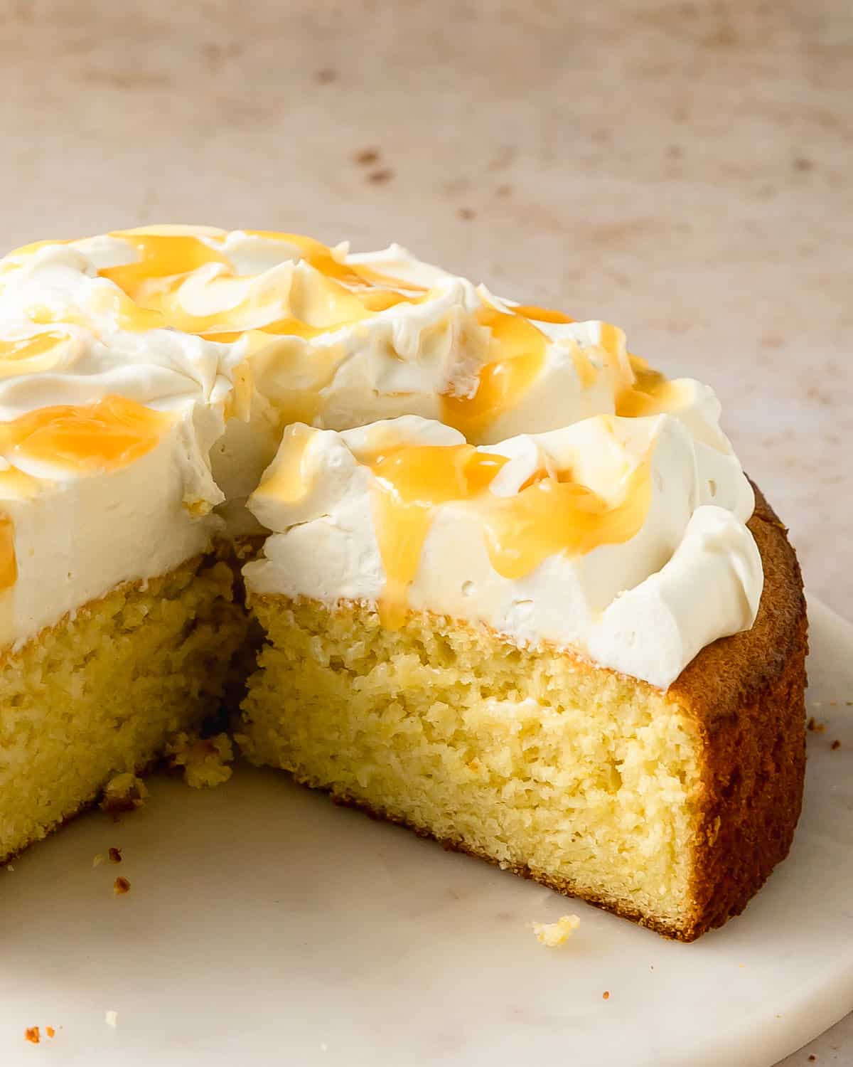 Limoncello mascarpone cake is a deliciously soft and tender lemon cake infused with limoncello liqueur flavor. This Italian lemon cake is topped with a rich and creamy mascarpone frosting and tart lemon curd. Make this limoncello cake anytime you need a simple, but stunning dessert.