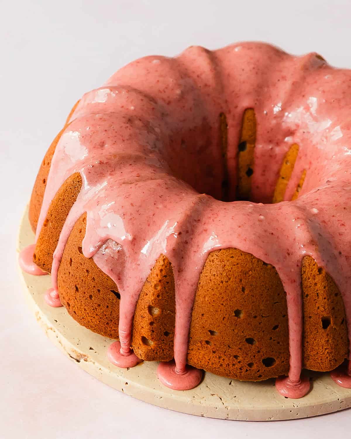 Strawberry pound cake is a buttery, moist, dense and tender pound cake made with fresh strawberries. Top with this pound cake with fresh strawberries with a sweet and creamy fresh strawberry icing. Enjoy this easy to make, strawberry filled classic pound cake for breakfast, brunch or dessert. 