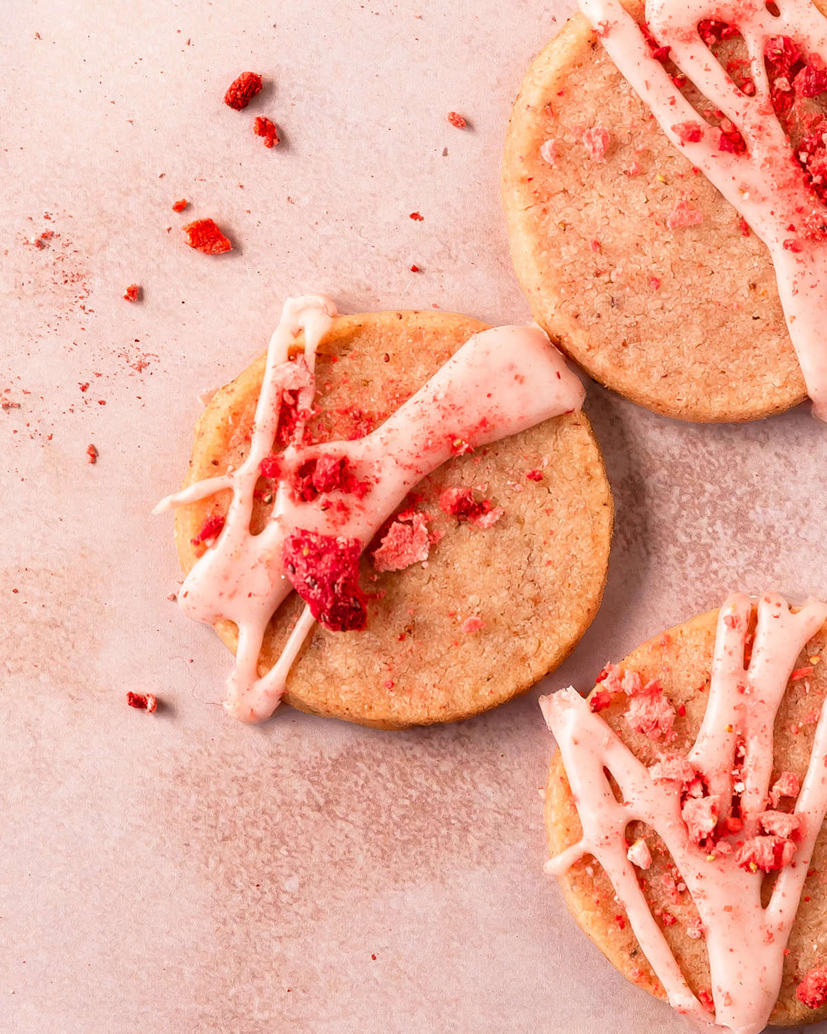 Strawberry shortbread cookies are buttery shortbread cookies filled with sweet and tart strawberry flavor. These strawberry butter cookies get their pink hue and berry flavor thanks to freeze dried strawberries in both the cookie and glaze. Make these pink shortbread cookies for a taste of spring and summer all year long.