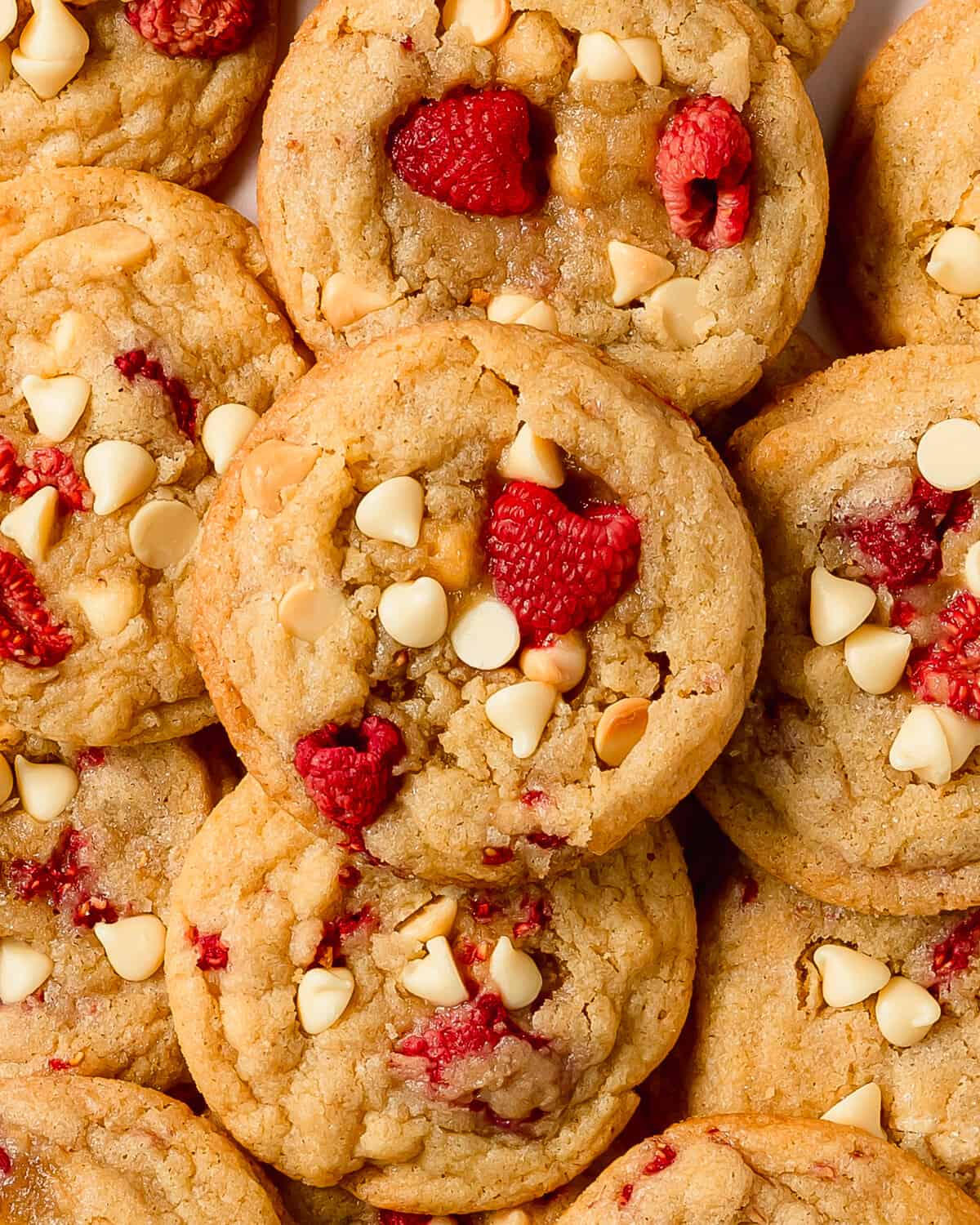 White chocolate raspberry cookies are soft, chewy and buttery sugar cookies filled with tart, juicy raspberries and creamy white chocolate. This raspberry white chocolate cookie recipe is no chill, quick and easy to make in one bowl. 