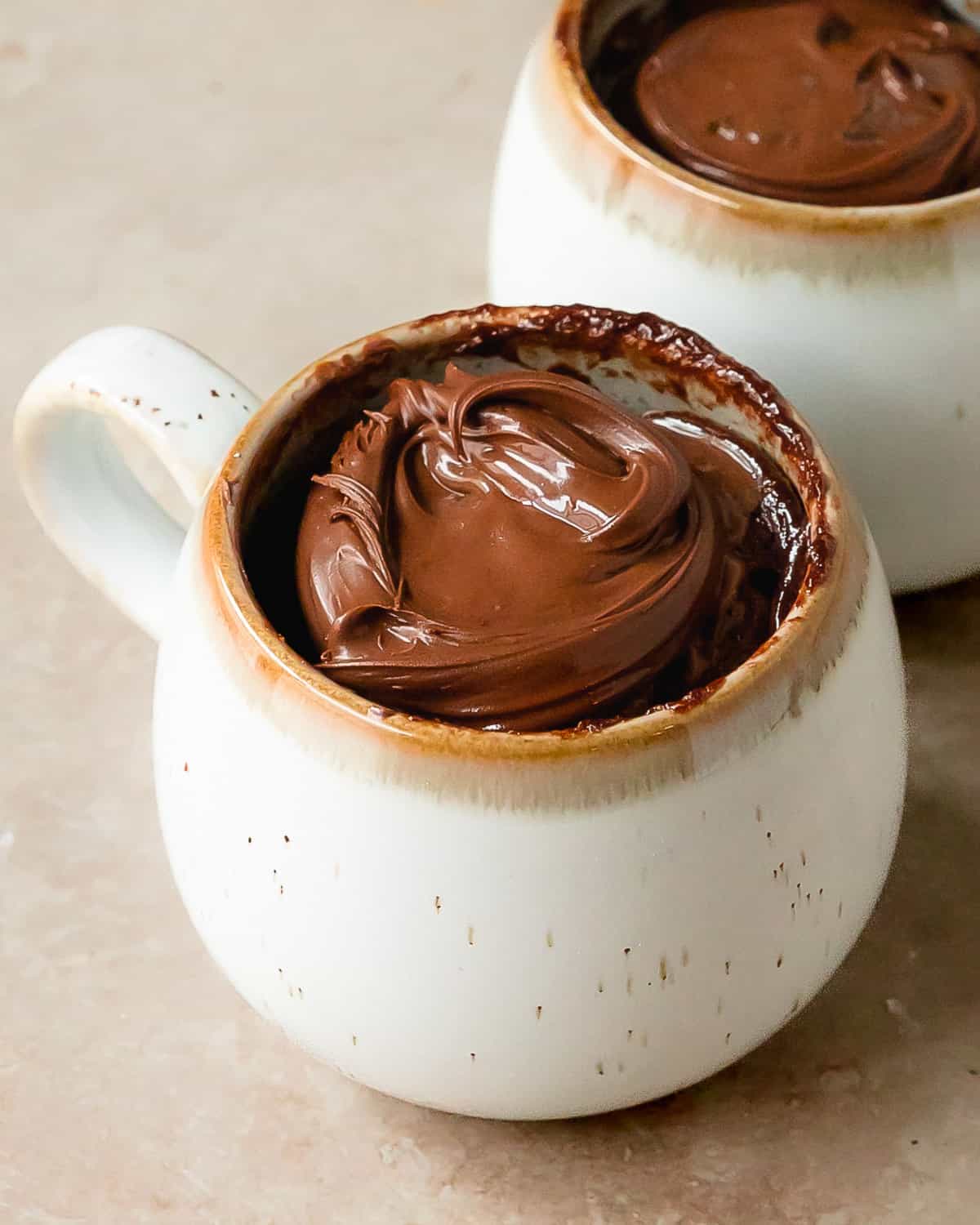 3 ingredient mug cake is a moist and fluffy 1 minute cake made in a a mug. This three ingredient mug cake is especially delicious when topped with your favorite topping such as Nutella or peanut butter. Make this cozy cake in a cup for the perfect single serve breakfast, snack or dessert. 