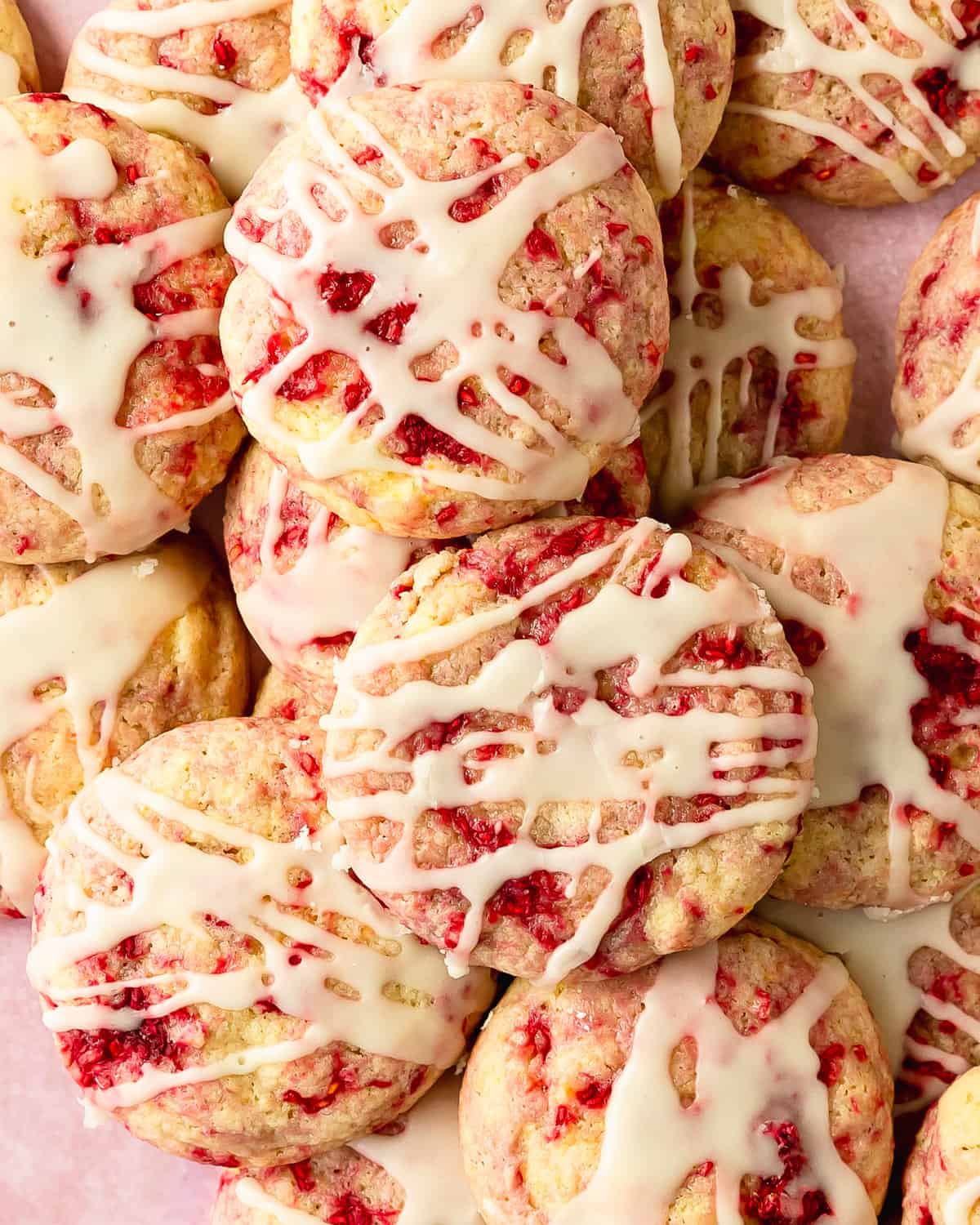 Lemon raspberry cookies are sweet. buttery, soft and fluffy lemon cookies filled with swirls of tart raspberries. Top these raspberry lemon cookies with a fresh lemon glaze for even more lemon flavor. This lemon and raspberry cookie recipe is no chill and easy to make in one bowl. 