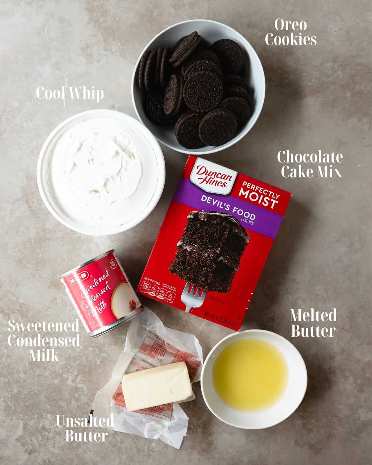 Gather Oreo cookies, sweetened condensed milk, chocolate cake mix, cool whip and butter. 