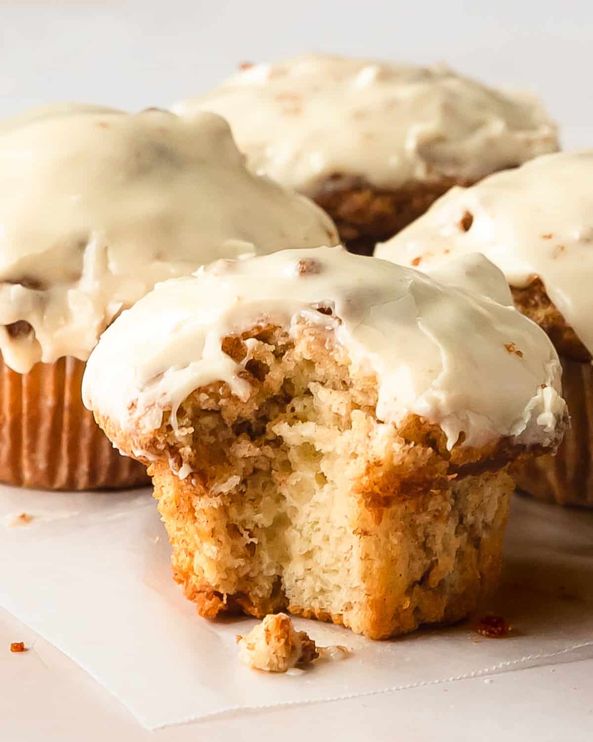Cinnamon roll muffins are wonderfully soft, light and fluffy no yeast muffins filled with ribbons of sweet cinnamon roll filling.  Once baked, these cute cinnamon rolls muffins are topped with a sweet and tangy cream cheese glaze. These cinnamon bun muffins are quick, easy to make and muffins are perfect for breakfasts or snacks.