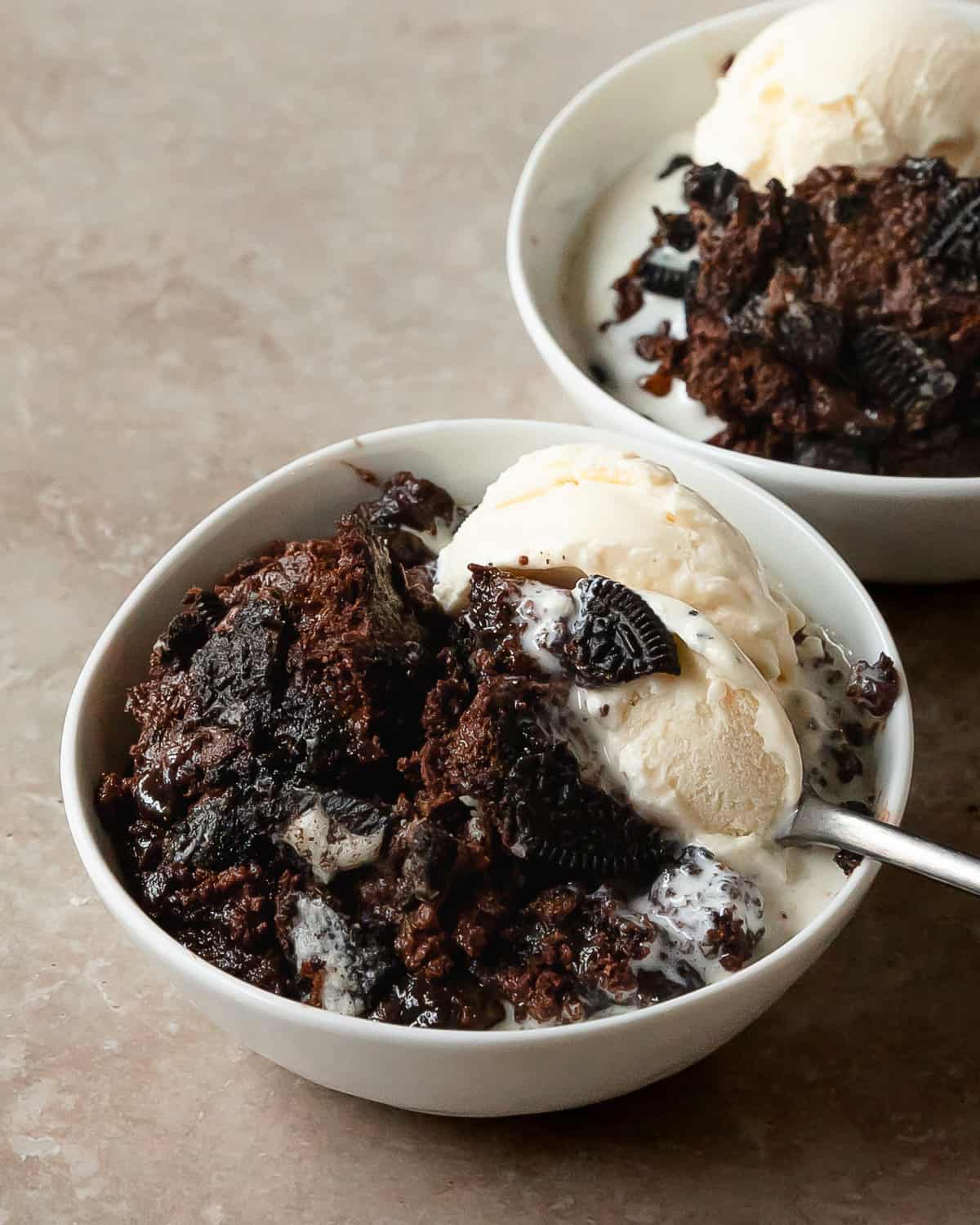 Oreo dump cake is a quick, easy to make, rich and chocolatey cookies and cream dessert. This Oreo dump cake recipe is made from 5 simple ingredients layered into a baking dish. Top this decadent Oreo cake with cold vanilla ice cream for the perfect one dish dessert.  