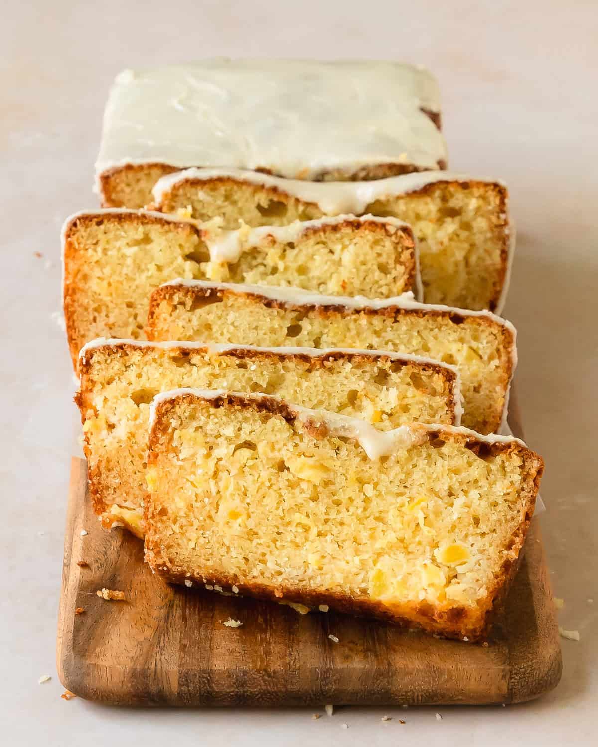 Pineapple bread is a soft, moist and buttery pineapple quick bread filled with crushed pineapple. This easy to make pineapple loaf cake is topped with a sweet pineapple glaze for even more fresh tropical flavor. 