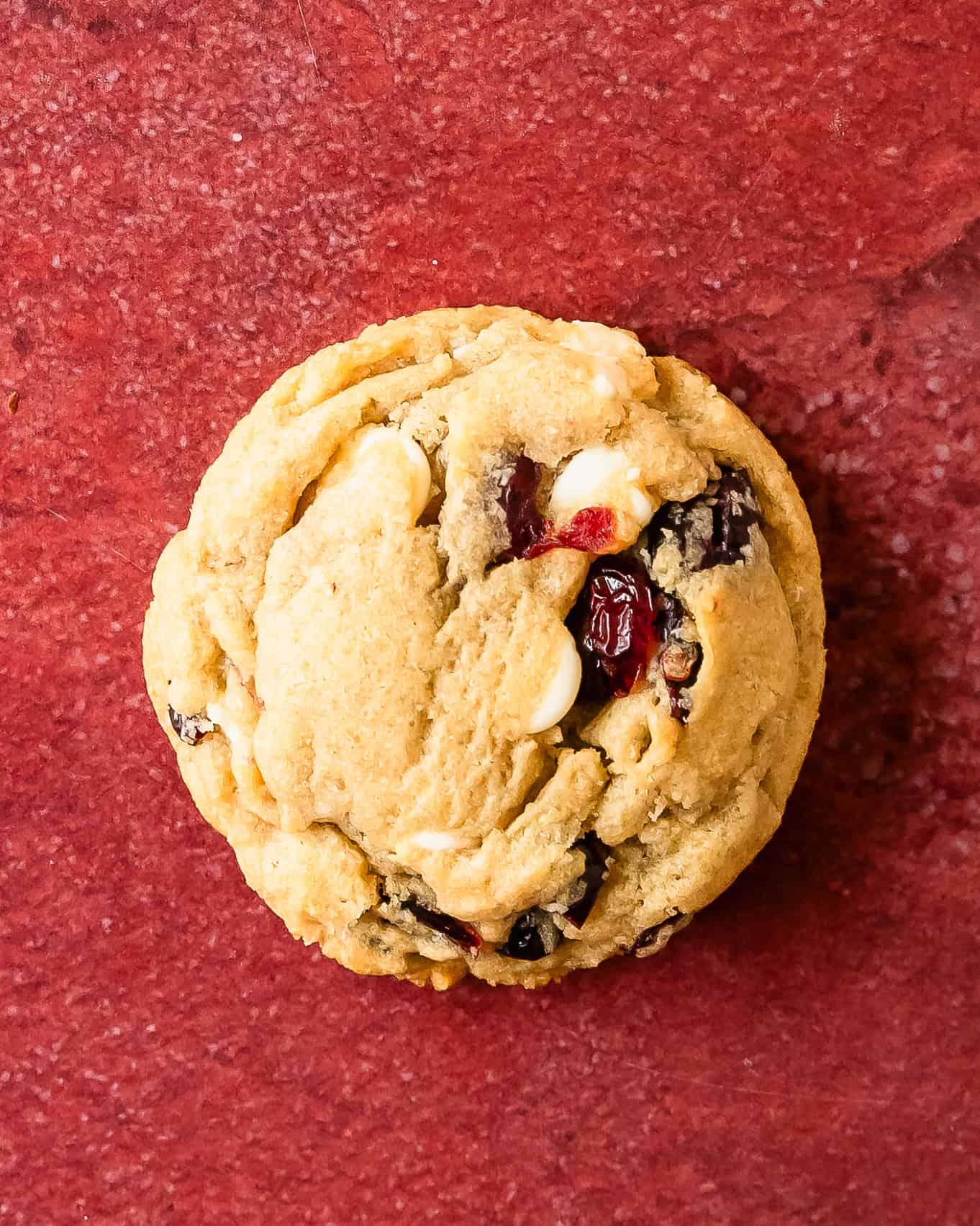 Cranberry white chocolate cookies are thick, soft and buttery cookies with crisp edges and chewy centers. They’re filled with sweet and creamy morsels of white chocolate chips and tangy cranberries. These white chocolate cranberry cookies are easy to make and are a great festive cookie.