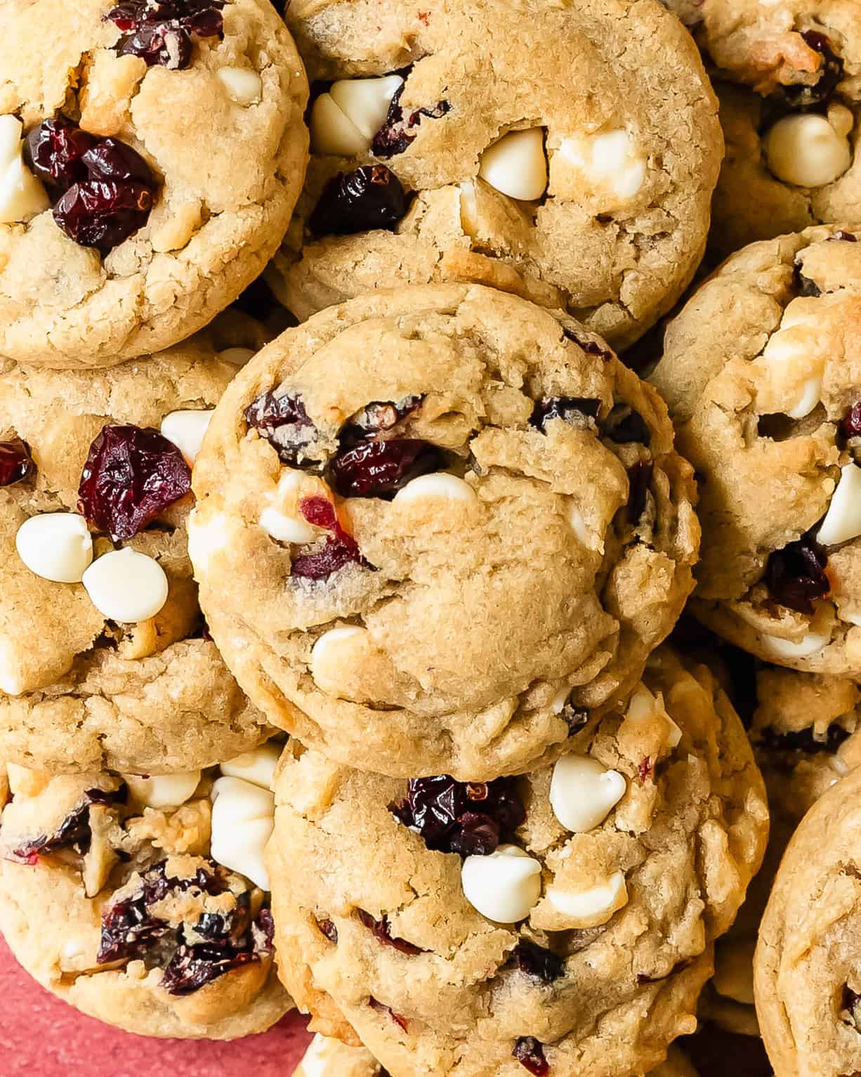 White chocolate cranberry cookies are thick, soft and buttery cookies with crisp edges and chewy centers. They’re filled with sweet and creamy morsels of white chocolate chips and tangy cranberries. These white chocolate cranberry cookies are easy to make and are a great festive cookie.