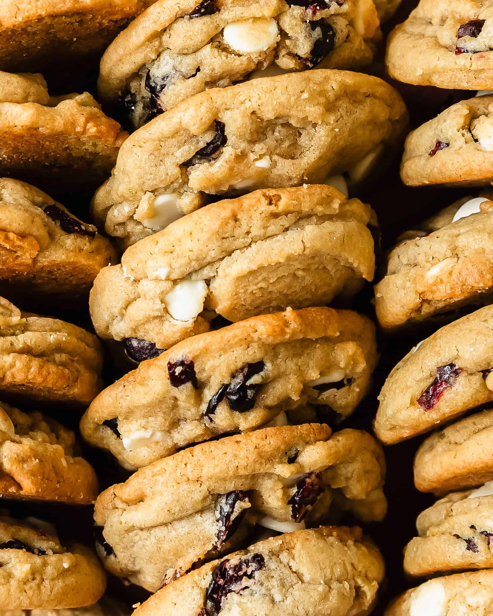 White chocolate cranberry cookies are thick, soft and buttery cookies with crisp edges and chewy centers. They’re filled with sweet and creamy morsels of white chocolate chips and tangy cranberries. These white chocolate cranberry cookies are easy to make and are a great festive cookie.
