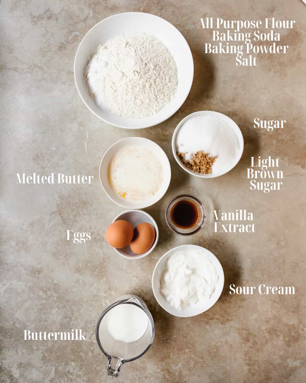 Coffee Cake Muffins: Gather all purpose flour, baking powder, baking soda, salt, butter, light brown sugar, sugar, eggs, vanilla extract, sour cream and milk.