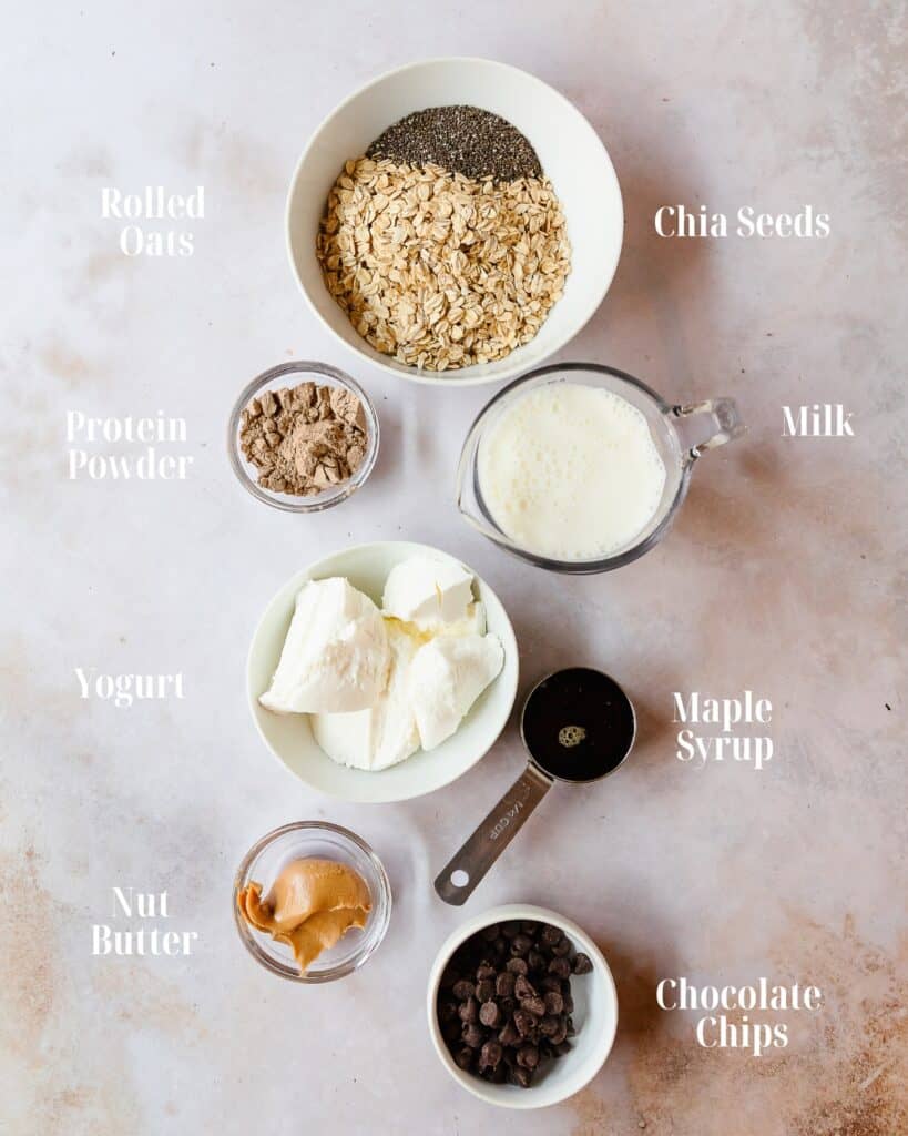 Gather Oats, chia seeds, milk, yogurt, protein powder, nut butter, maple syrup and chocolate chips.