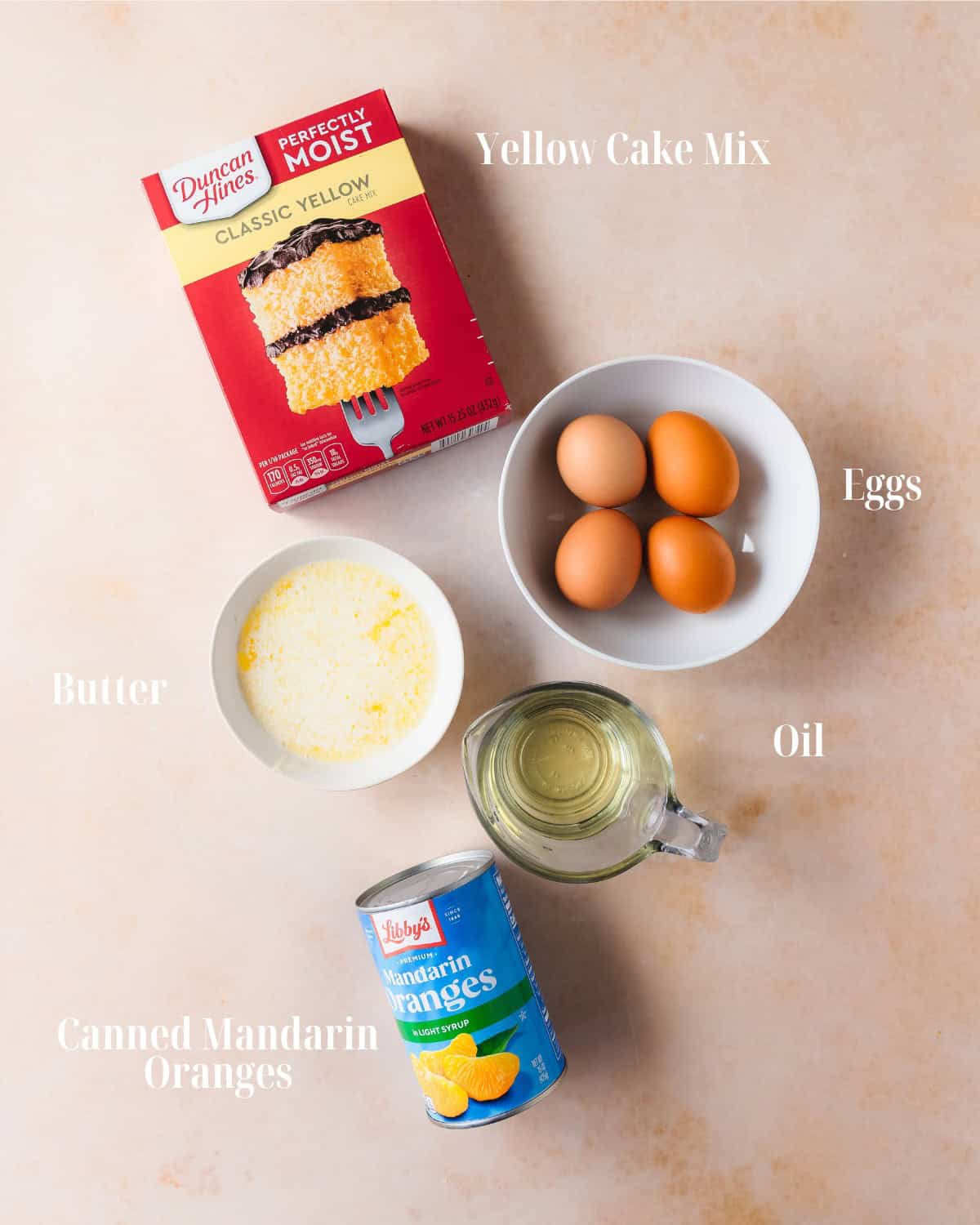 Mandarin Cake Ingredients: Gather all cake mix, oil, melted butter, eggs and canned mandarin oranges.