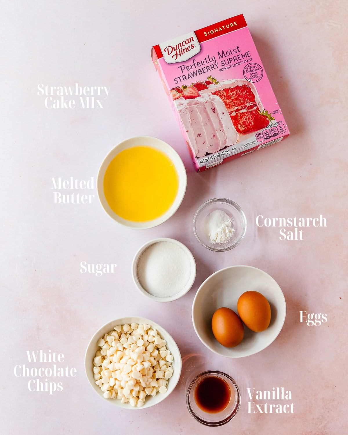Gather your preferred red velvet cake mix, cornstarch, melted butter, eggs, granulated sugar, vanilla extract and white chocolate chips.
