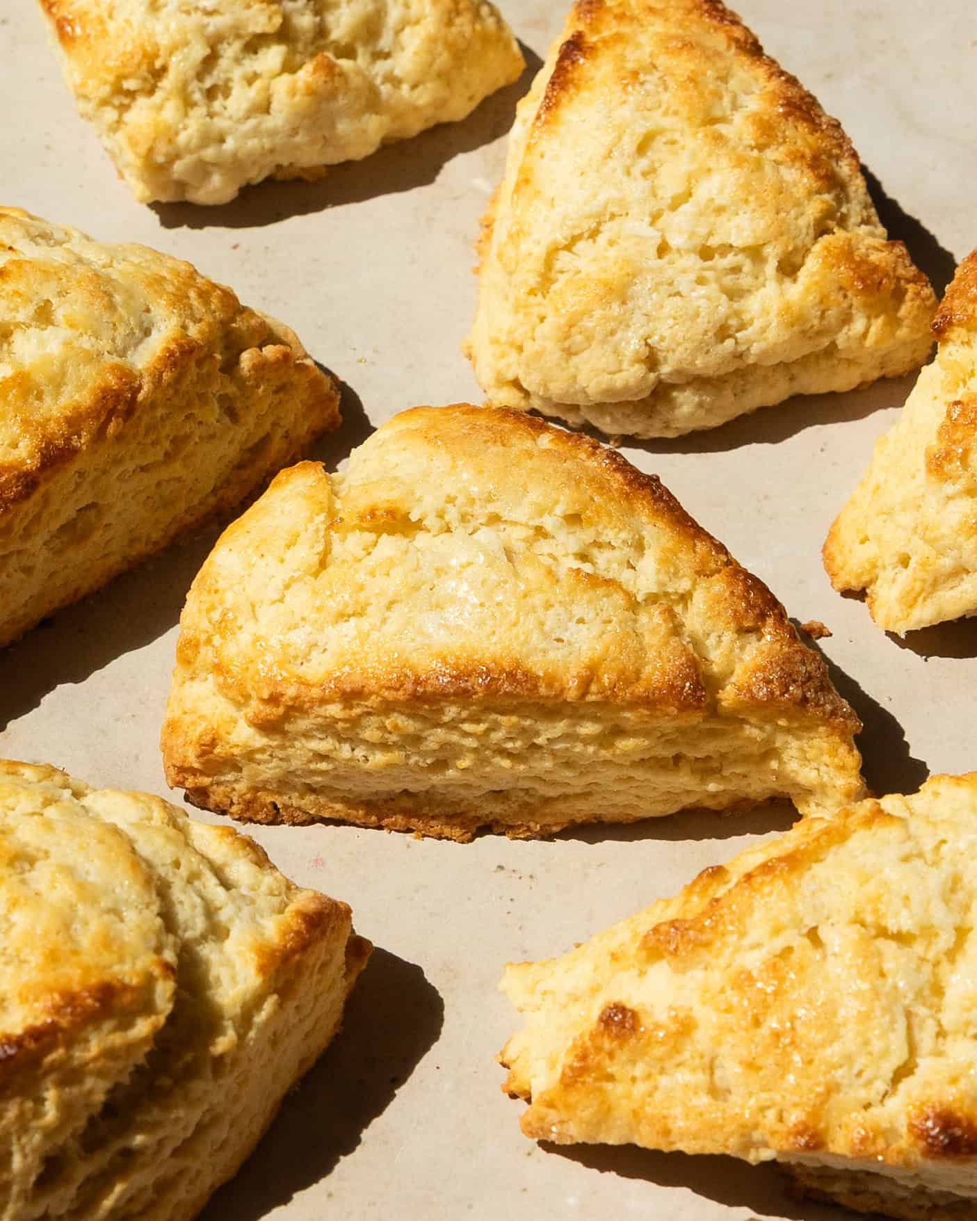Fresh buttermilk scones on a baking tray, golden brown.
