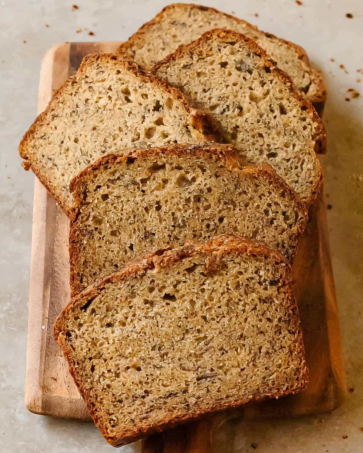 Moist cottage cheese banana bread sliced on a wooden board.