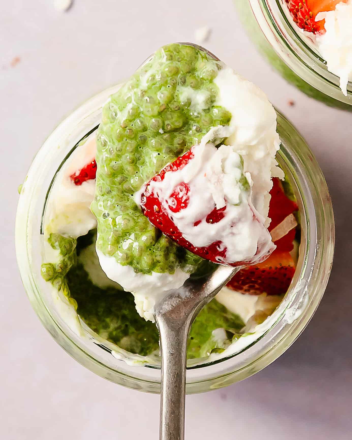 Healthy matcha chia pudding breakfast with layered chia pudding and berries.