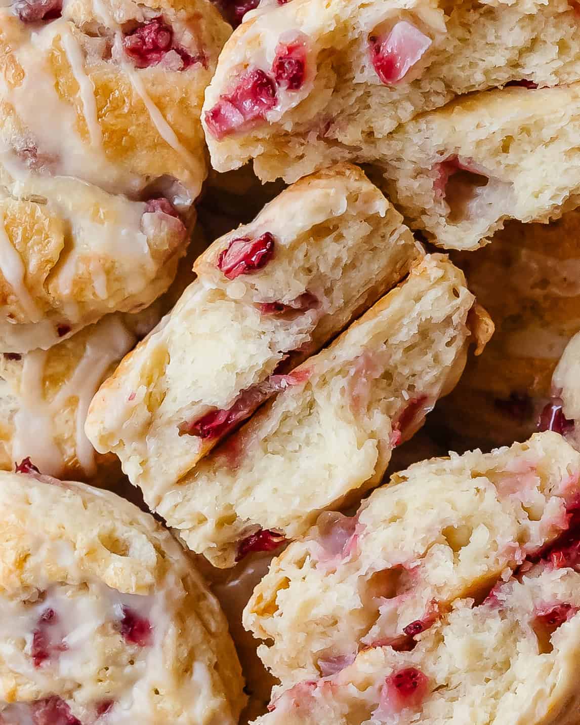Awarm strawberry biscuit showing the soft, fluffy center filled with berries.