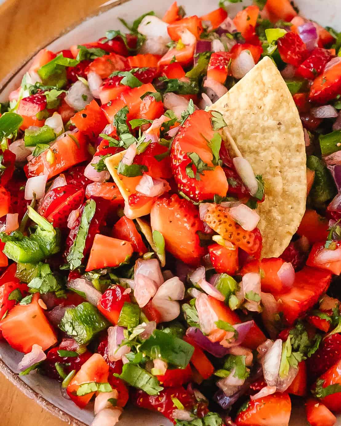 Strawberry salsa spooned onto crispy tortilla chips.