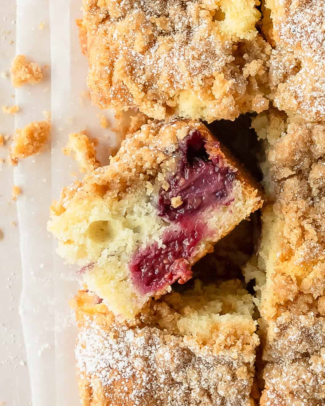 Overhead view of blackberry coffee cake with crumb topping, fresh blackberries, and a tender cake base.