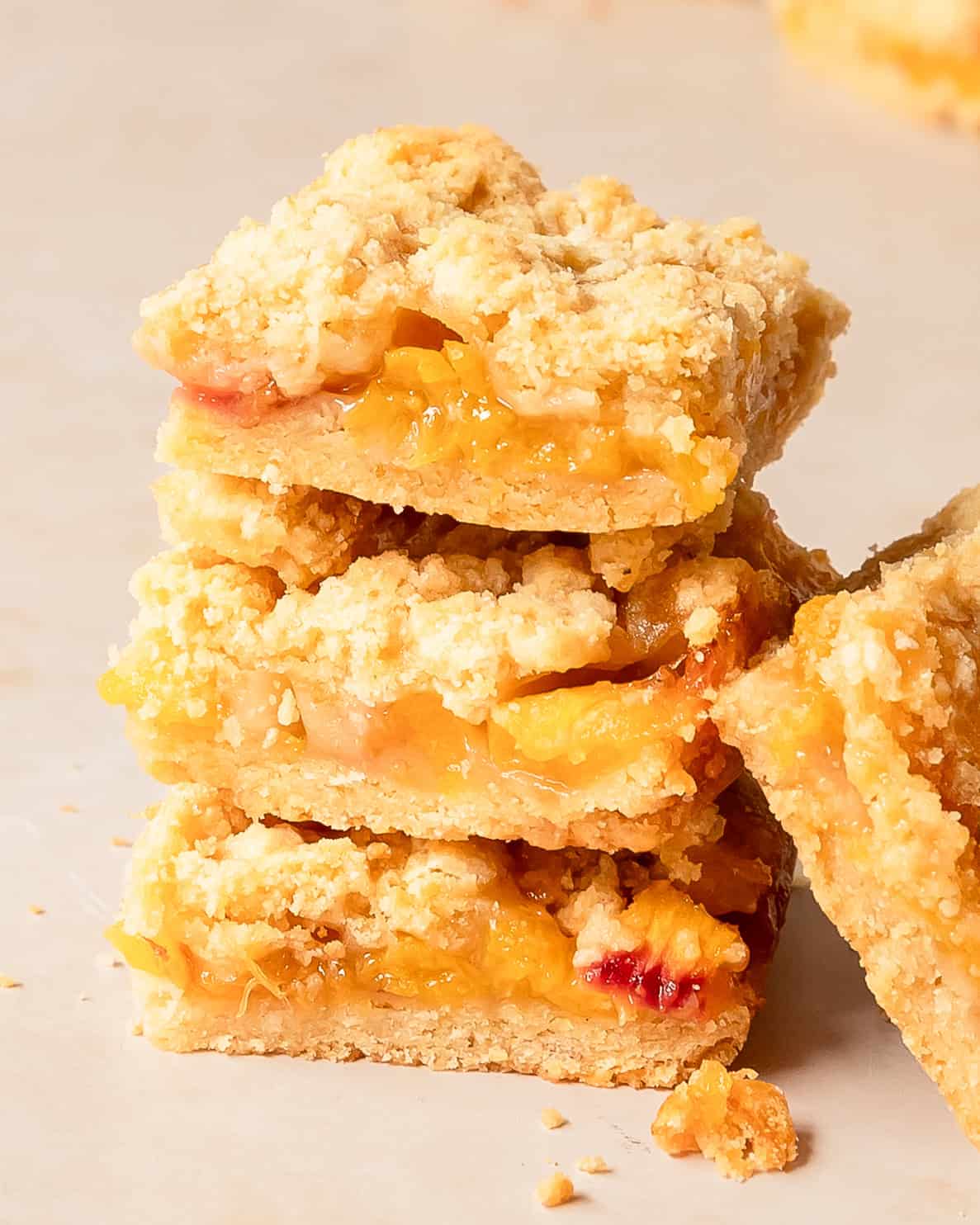 Peach bars are made with a soft and buttery shortbread crust layered with a sweet, juicy and jammy peach filling, topped with a crunchy, golden crumb topping. Made with fresh peaches and simple pantry ingredients, these peach crumble bars the perfect summer peach dessert.