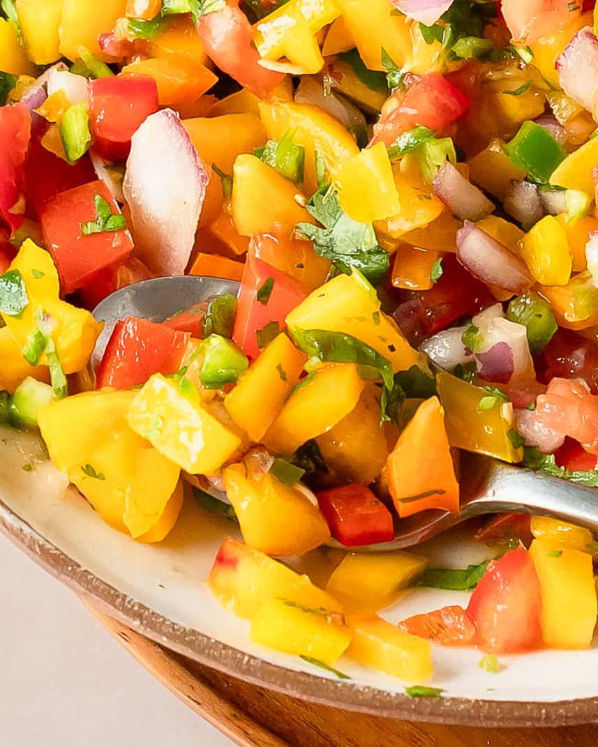 Easy peach salsa recipe featuring fresh peaches, red bell pepper, cilantro, and lime.