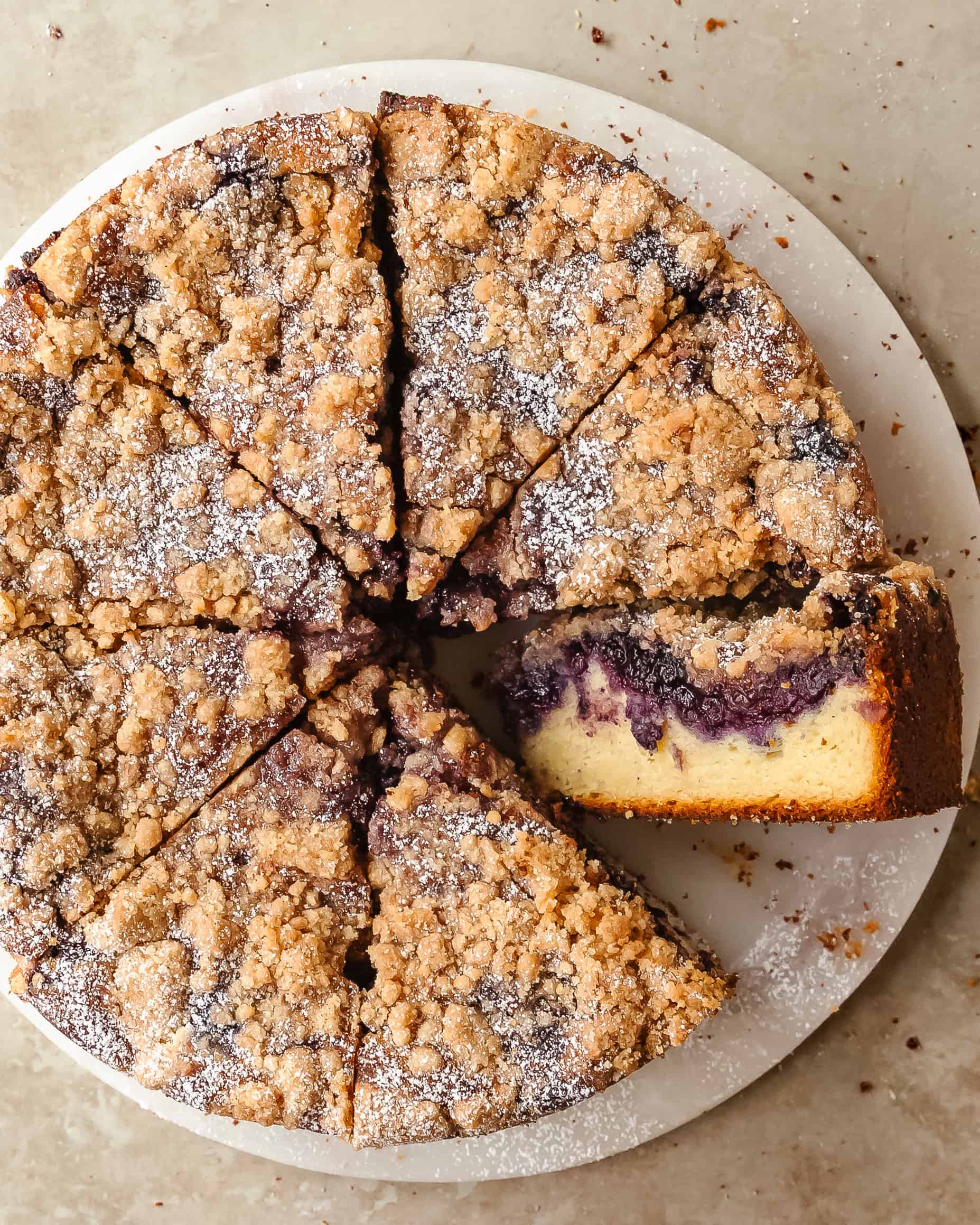 Close-up of homemade blueberry crumb cake with golden brown crumb topping and fresh blueberries