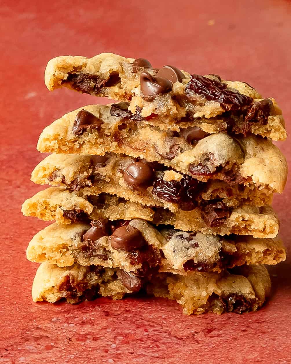 Detailed view of the chewy texture inside homemade cherry chocolate chip cookies broken in half.