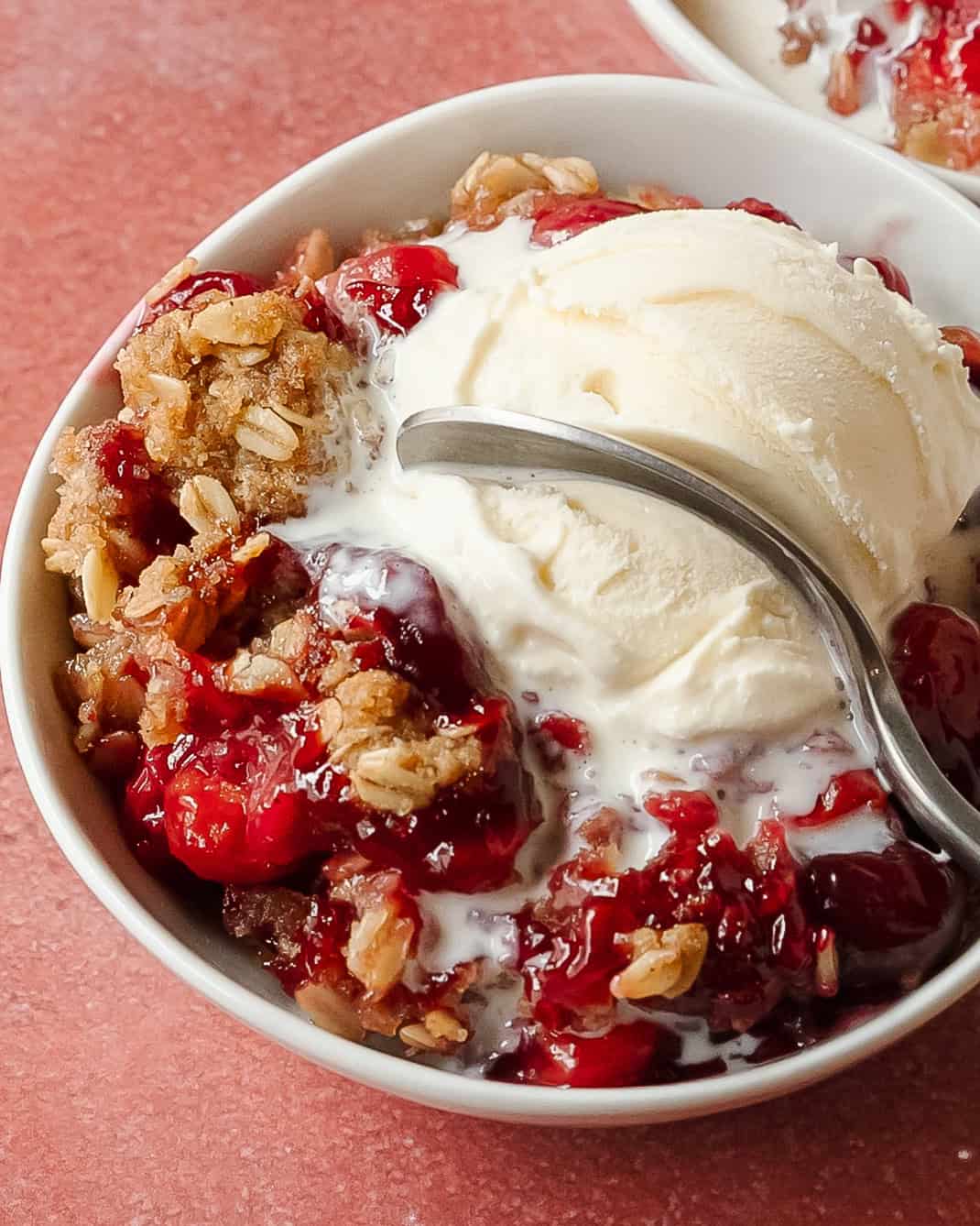 Cherry crisp with buttery oat topping and creamy vanilla ice cream.