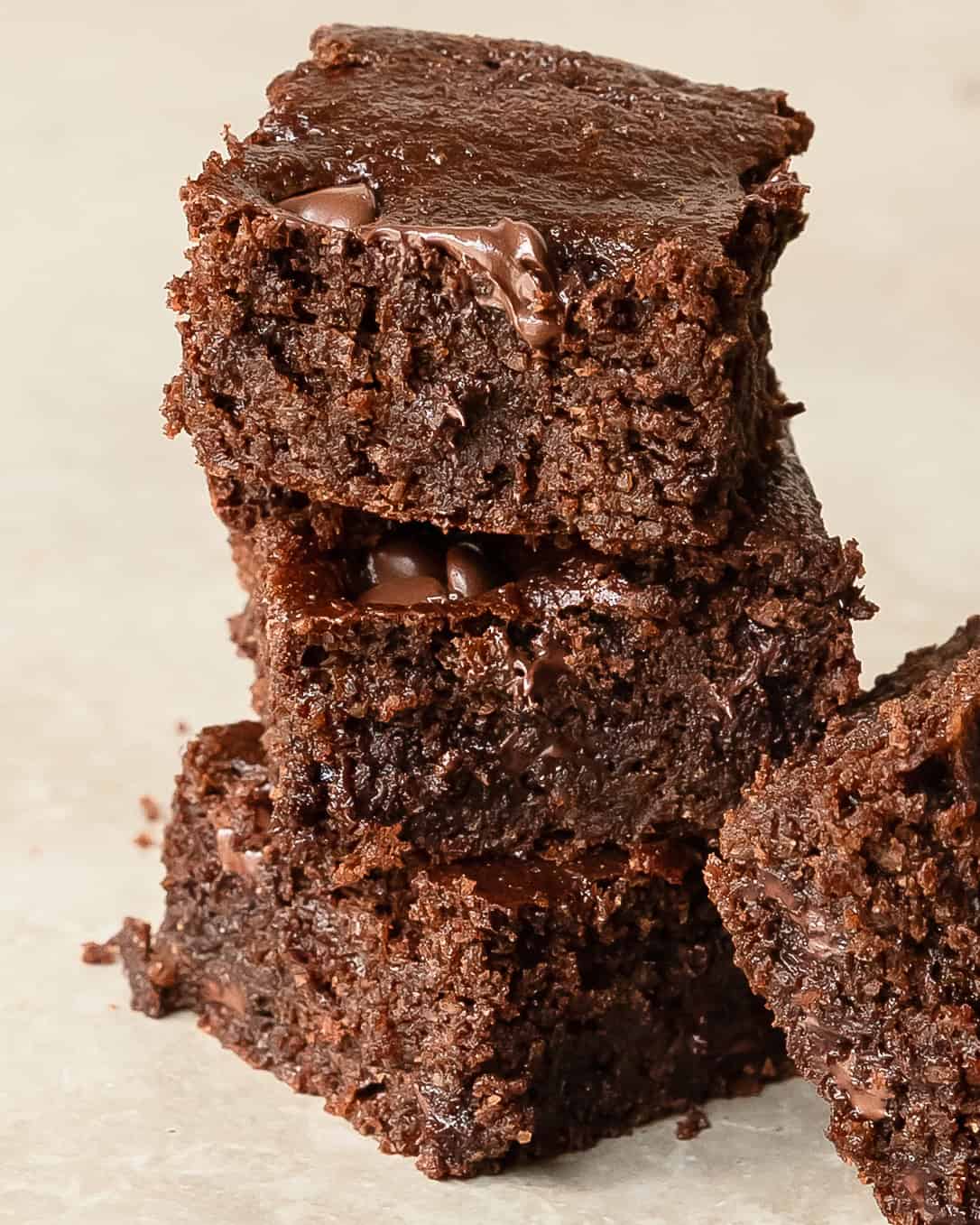 Fudgy protein brownies stacked for an easy and healthy chocolate dessert.