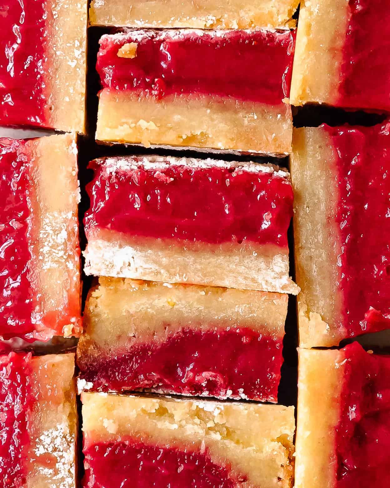 Close-up showing the creamy raspberry lemon layer and buttery shortbread base.