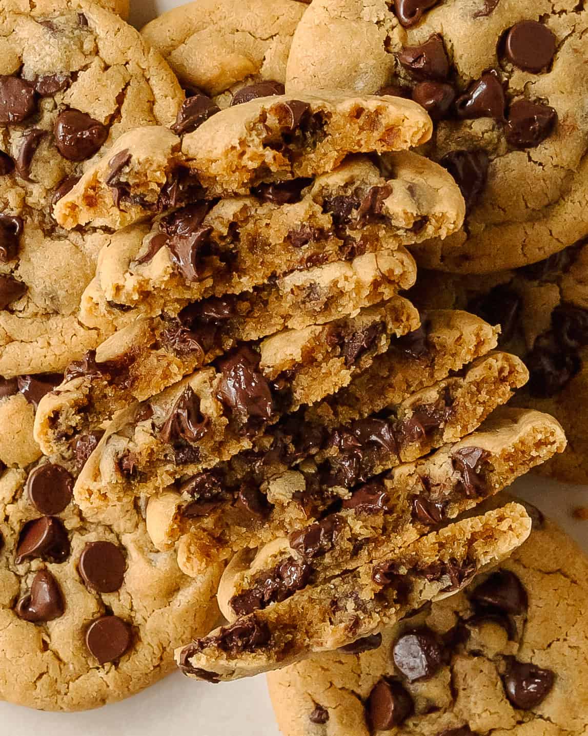 Stack of homemade peanut butter chocolate chip cookies on a wooden board.