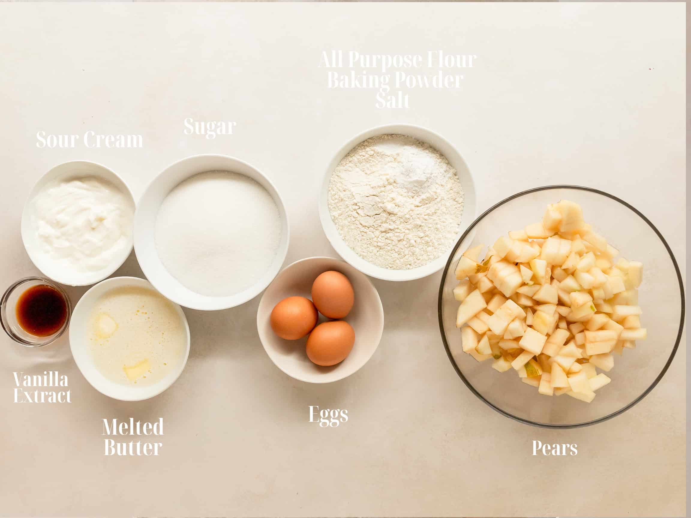 Ingredients to make french pear cake in bowls.