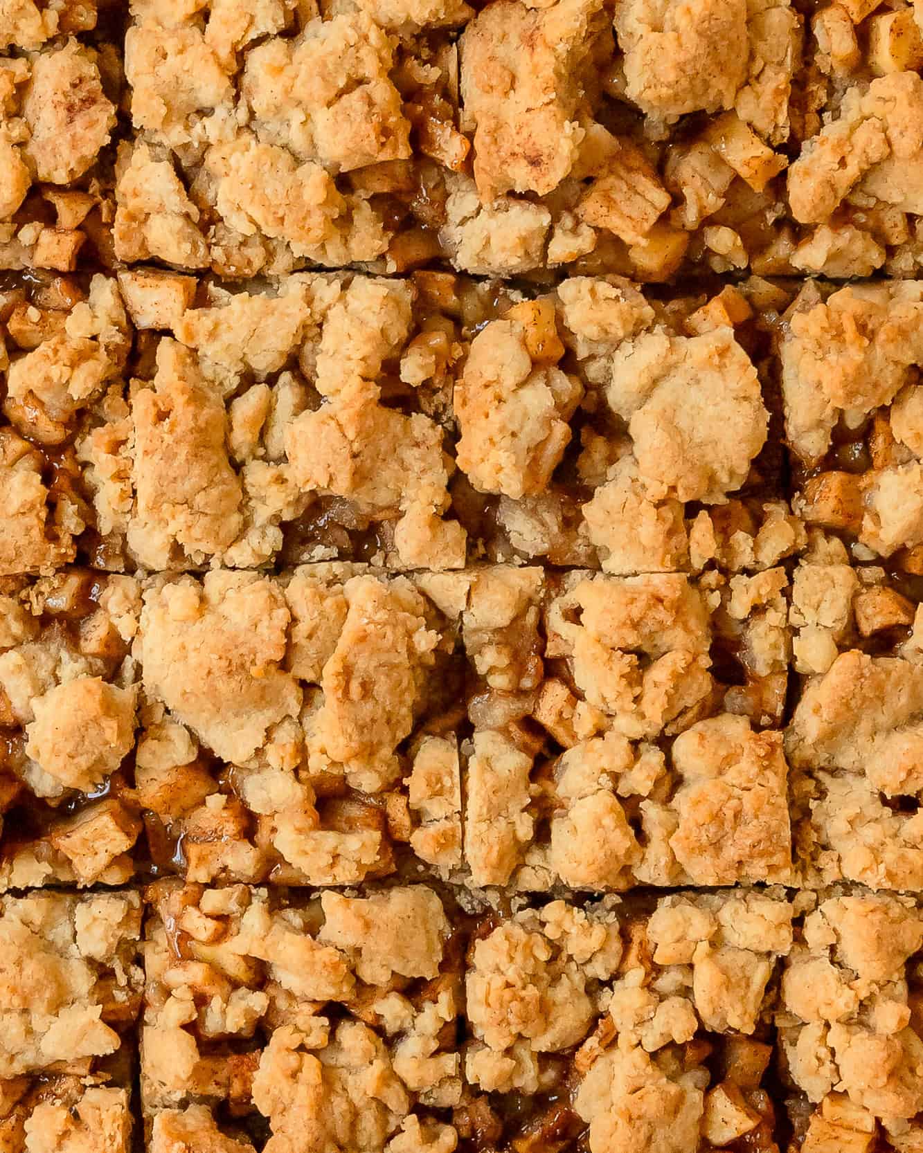 Overhead view of homemade apple pie bars cut into squares.