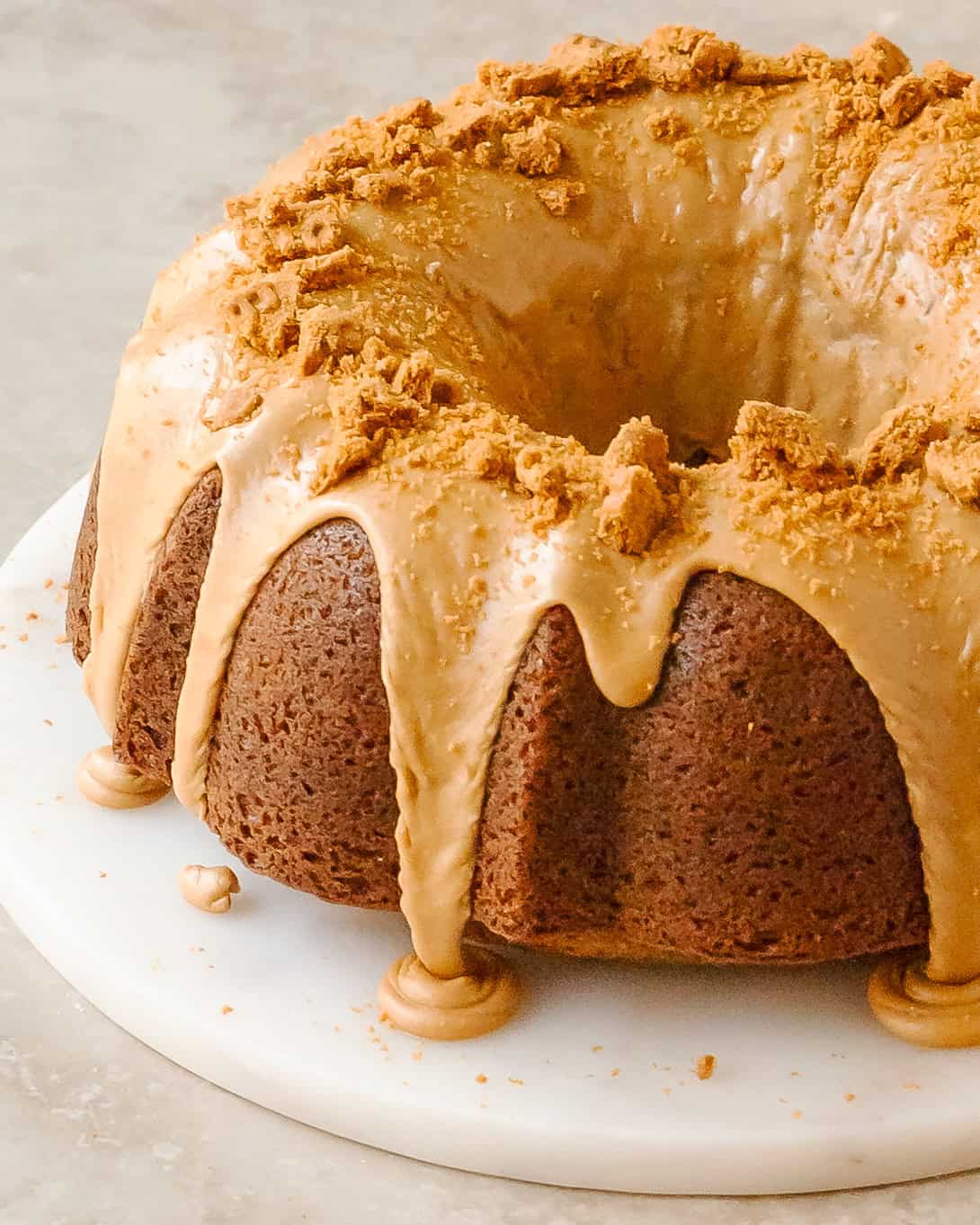 Cookie butter glaze dripping over the sides of Biscoff cake.