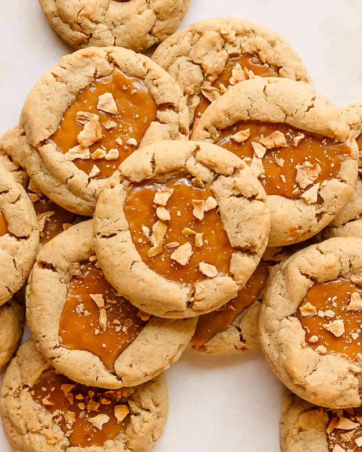 Freshly baked caramel apple cookies filled with dried apples and gooey salted caramel.