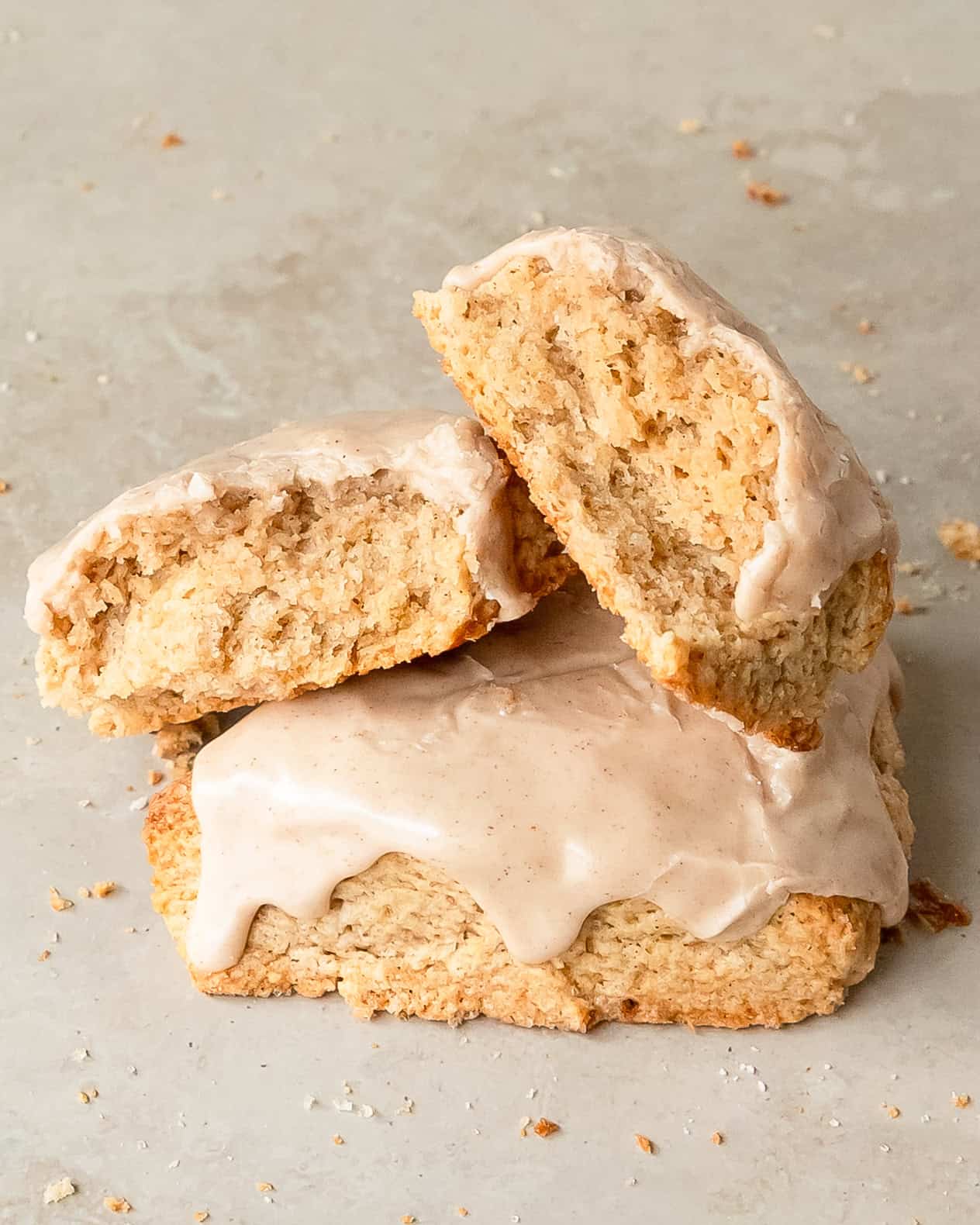 Cinnamon scone cut in half to reveal its soft interior and flaky layers.