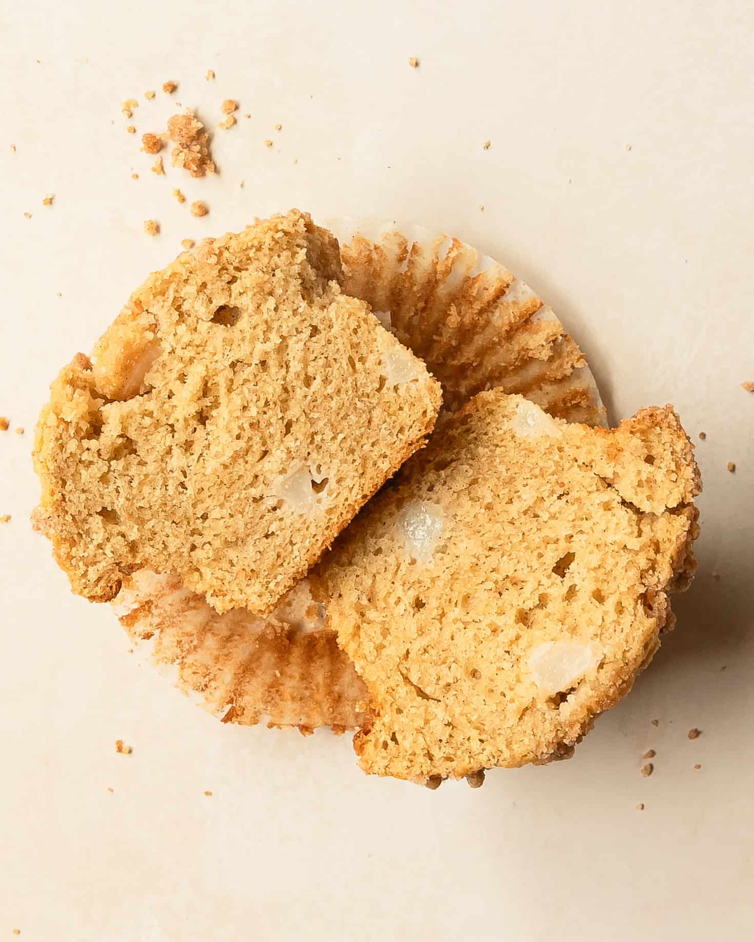 Pear muffin cut in half showing its soft, tender crumb.