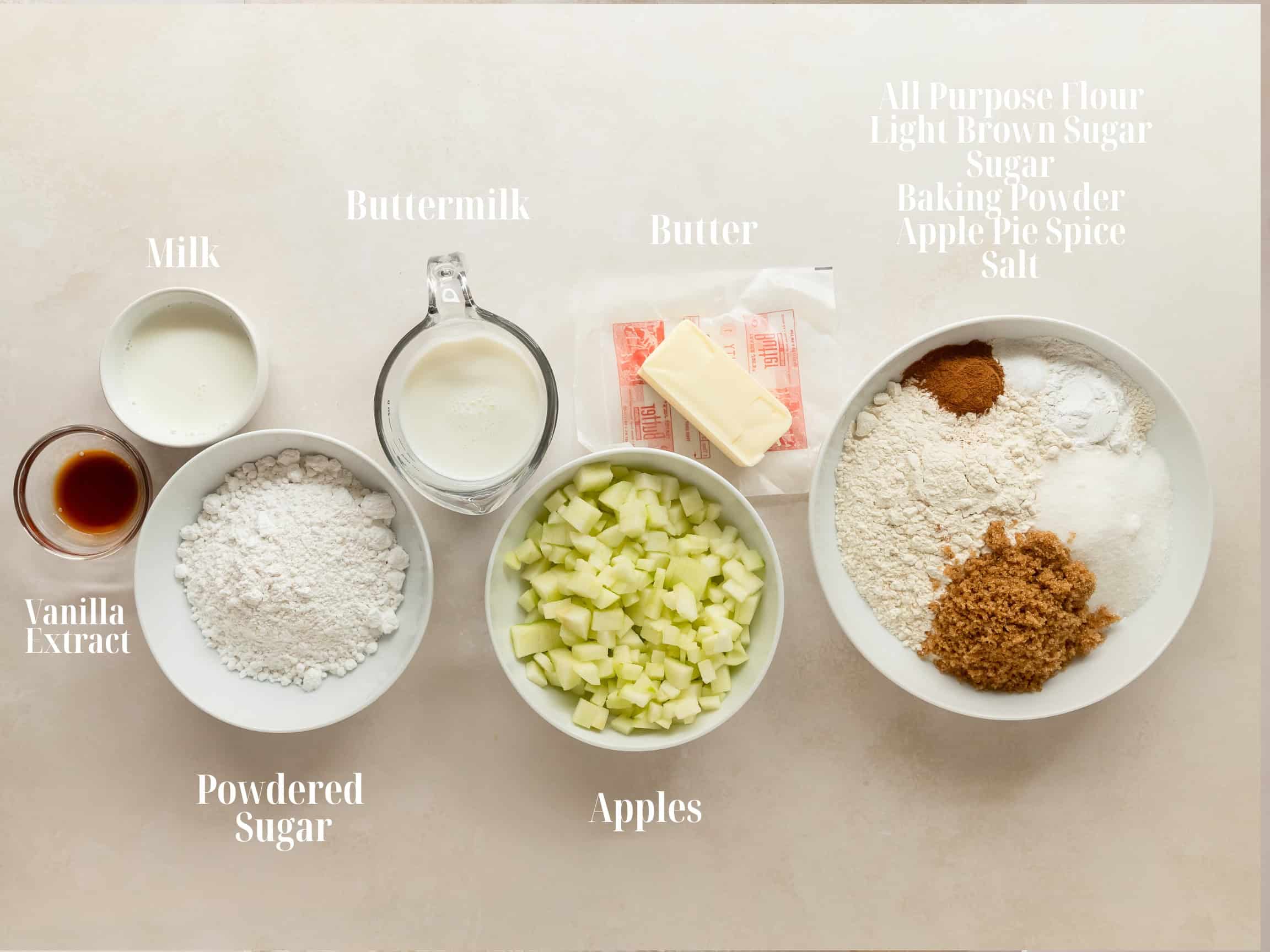 Igredients to make baked apple fritters in bowls.