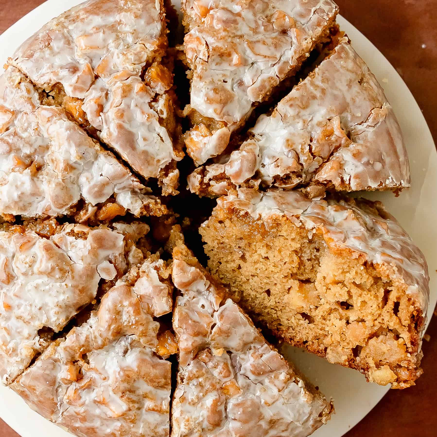 Homemade apple cake with golden brown edges and glaze.