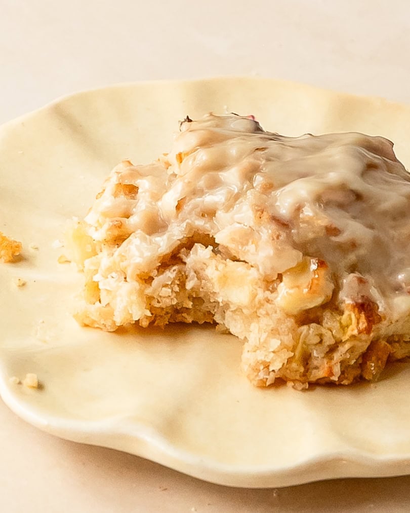 Homemade baked apple fritters served warm with a sweet vanilla glaze.