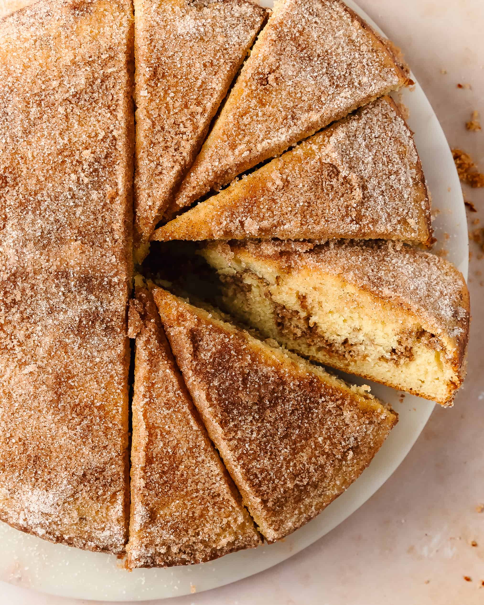Soft homemade cinnamon cake topped with golden cinnamon sugar.