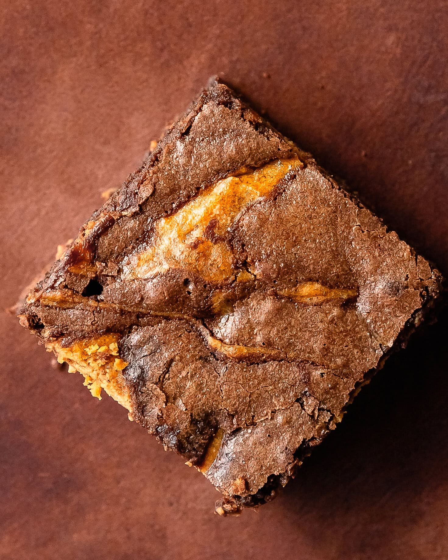 A slice of fudgy pumpkin brownie with a soft chocolate center.