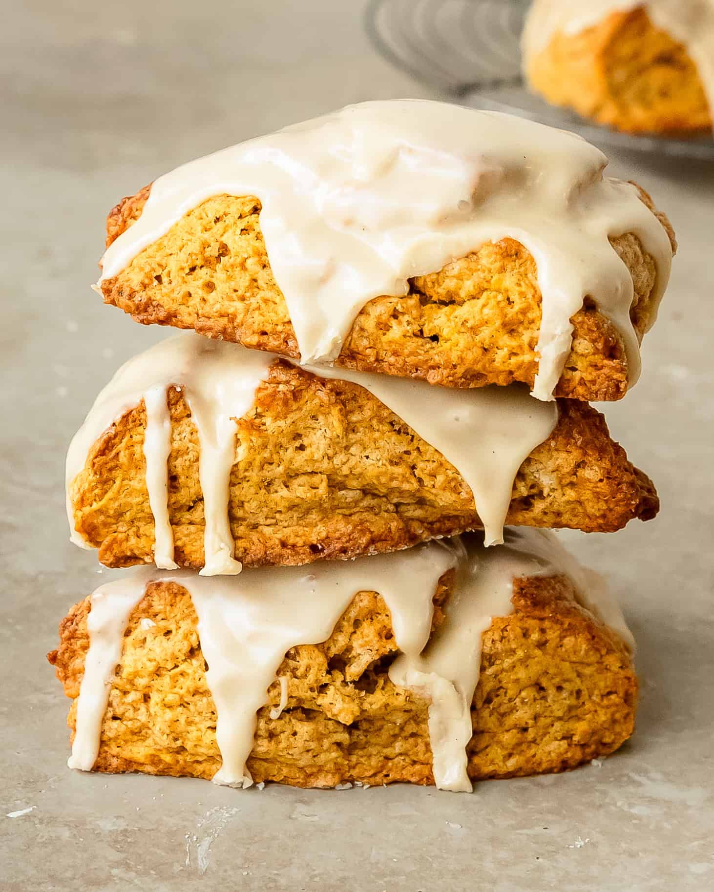 Golden pumpkin scones with pumpkin spice and sweet maple glaze.