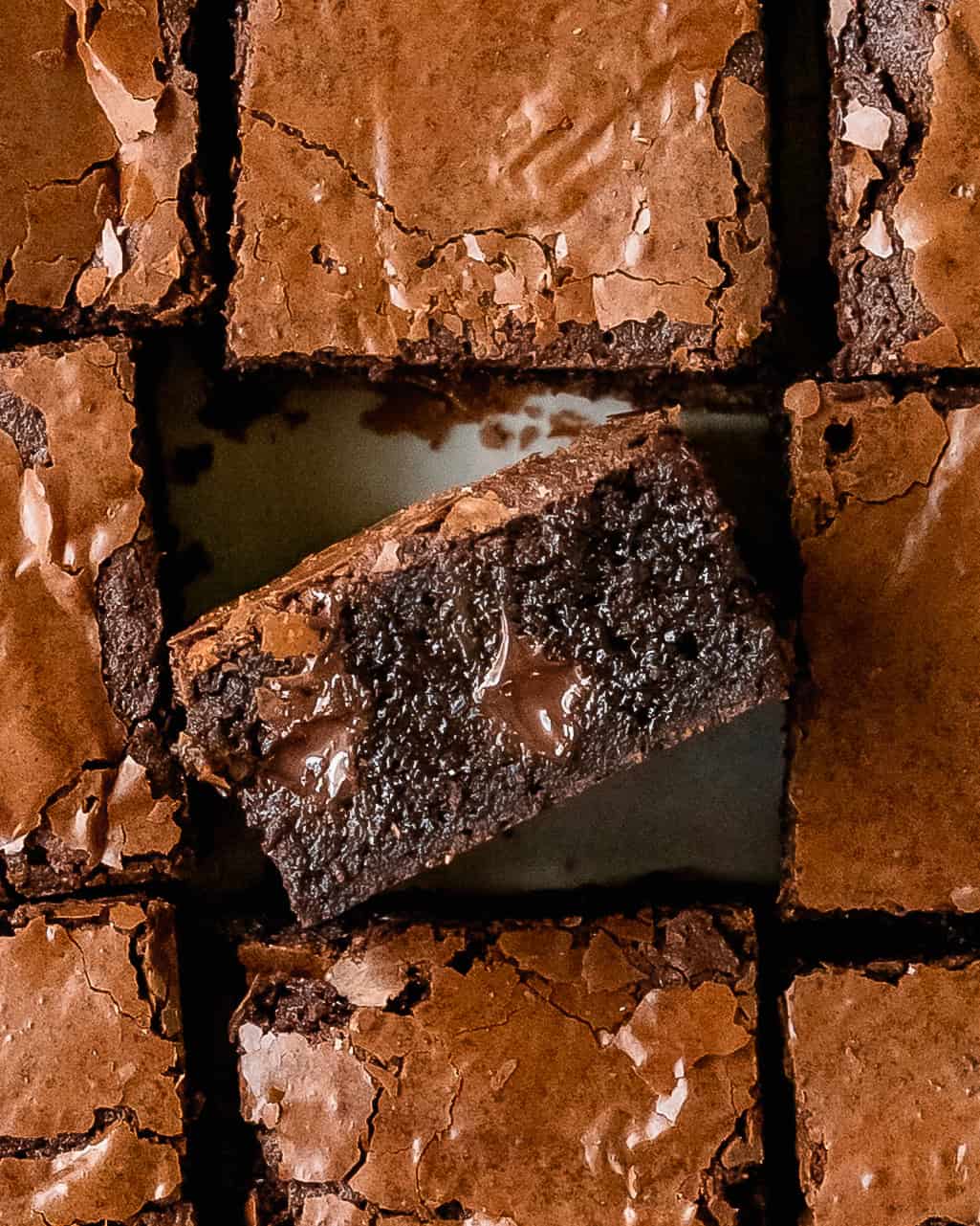 Close up of a fudgy brown butter brownie with a rich chocolate center.