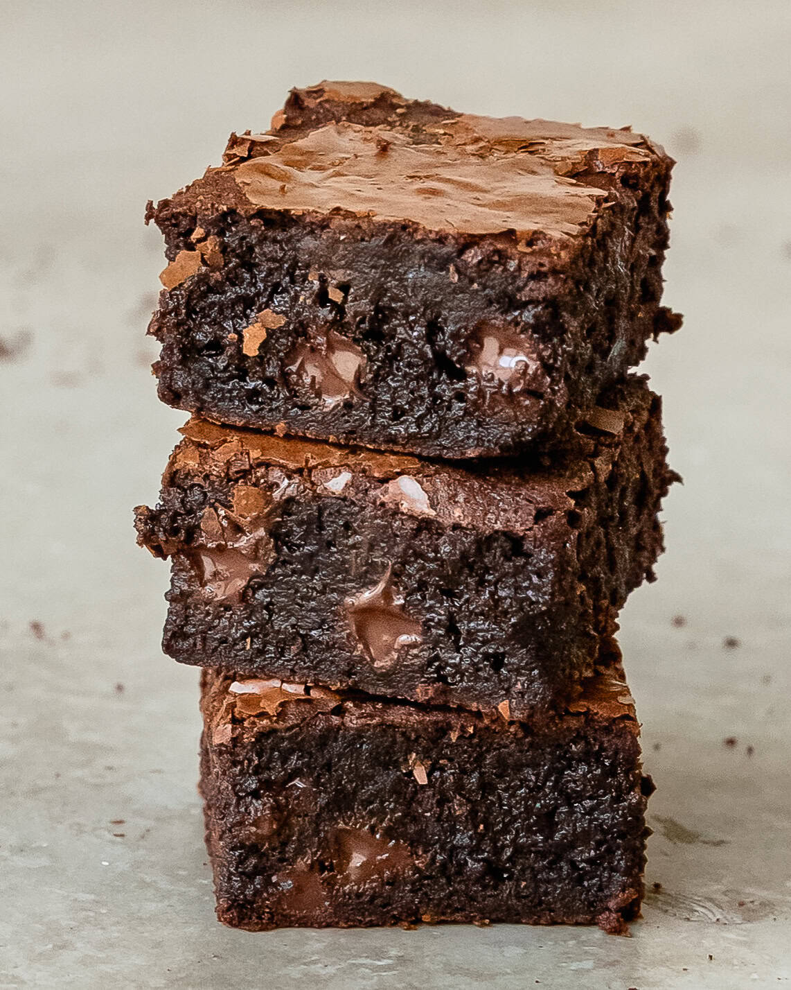 Stack of homemade brownies showing their fudgy chocolate centers.