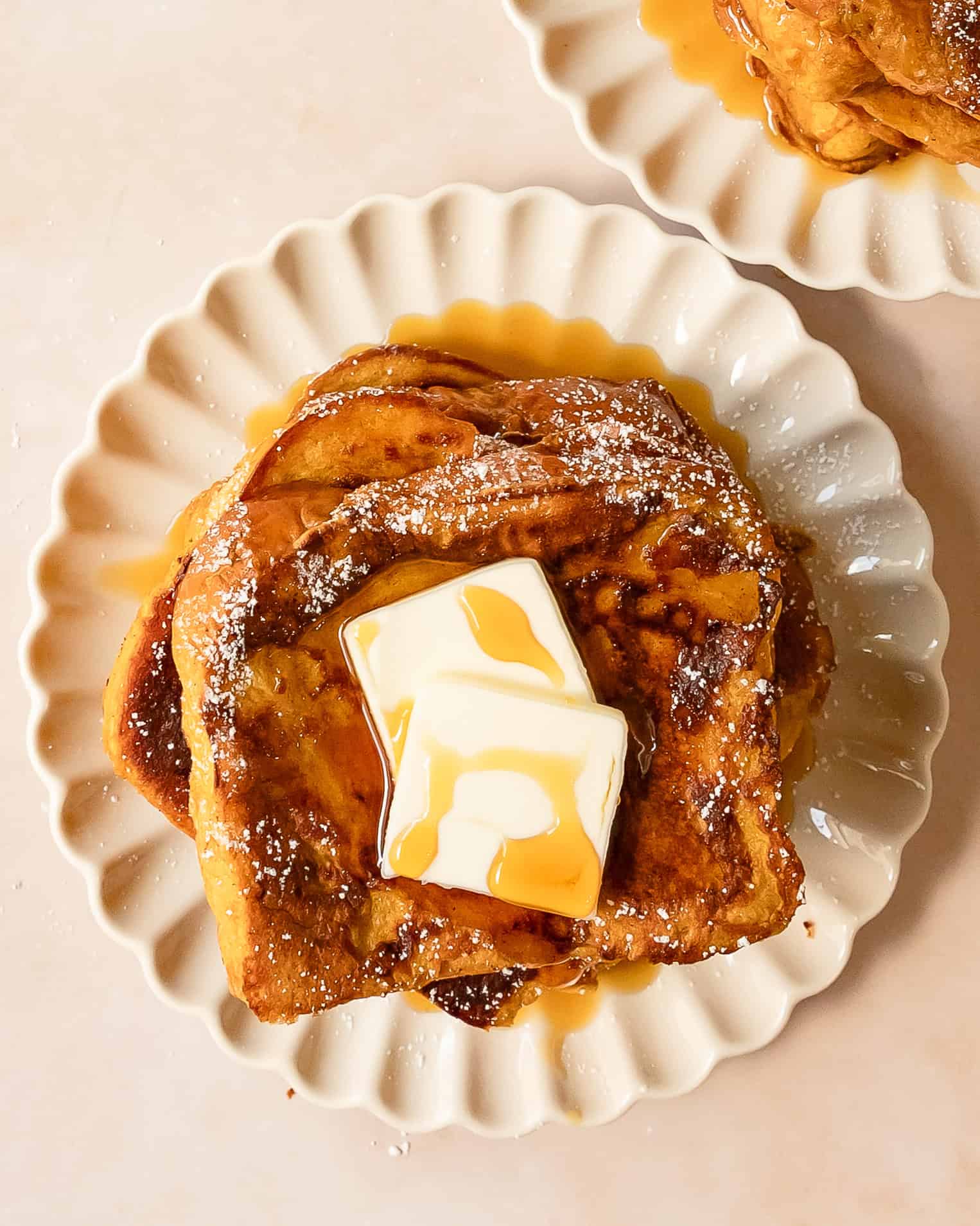 Pumpkin spice French toast cooked until golden brown and served with maple syrup.