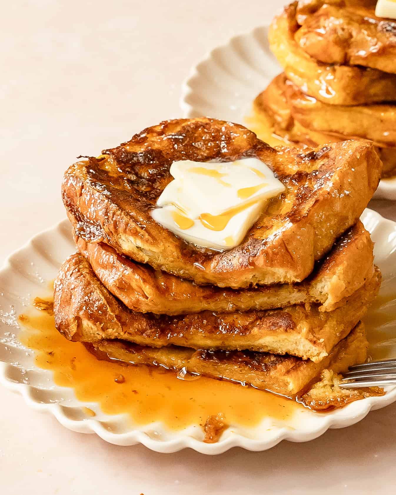 Homemade pumpkin French toast topped with powdered sugar for a cozy fall breakfast.
