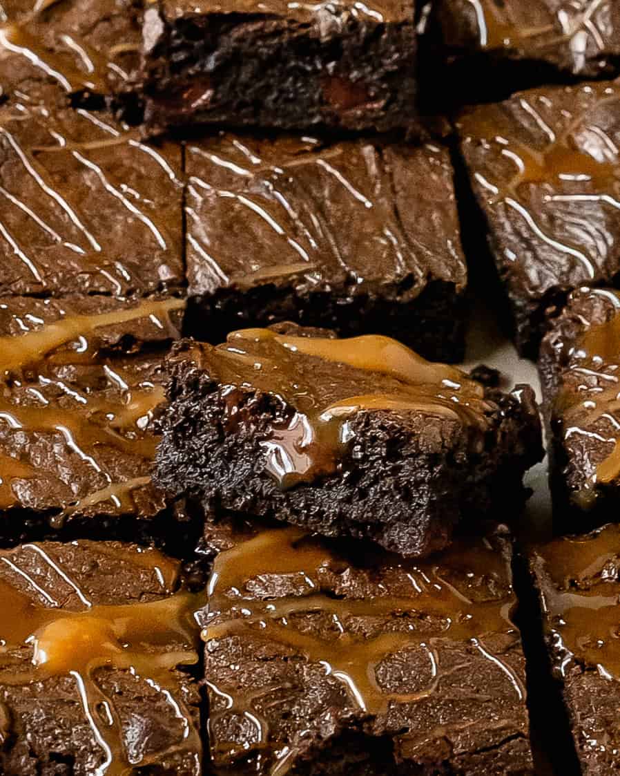 Slice of caramel brownie sticking up from the pan.